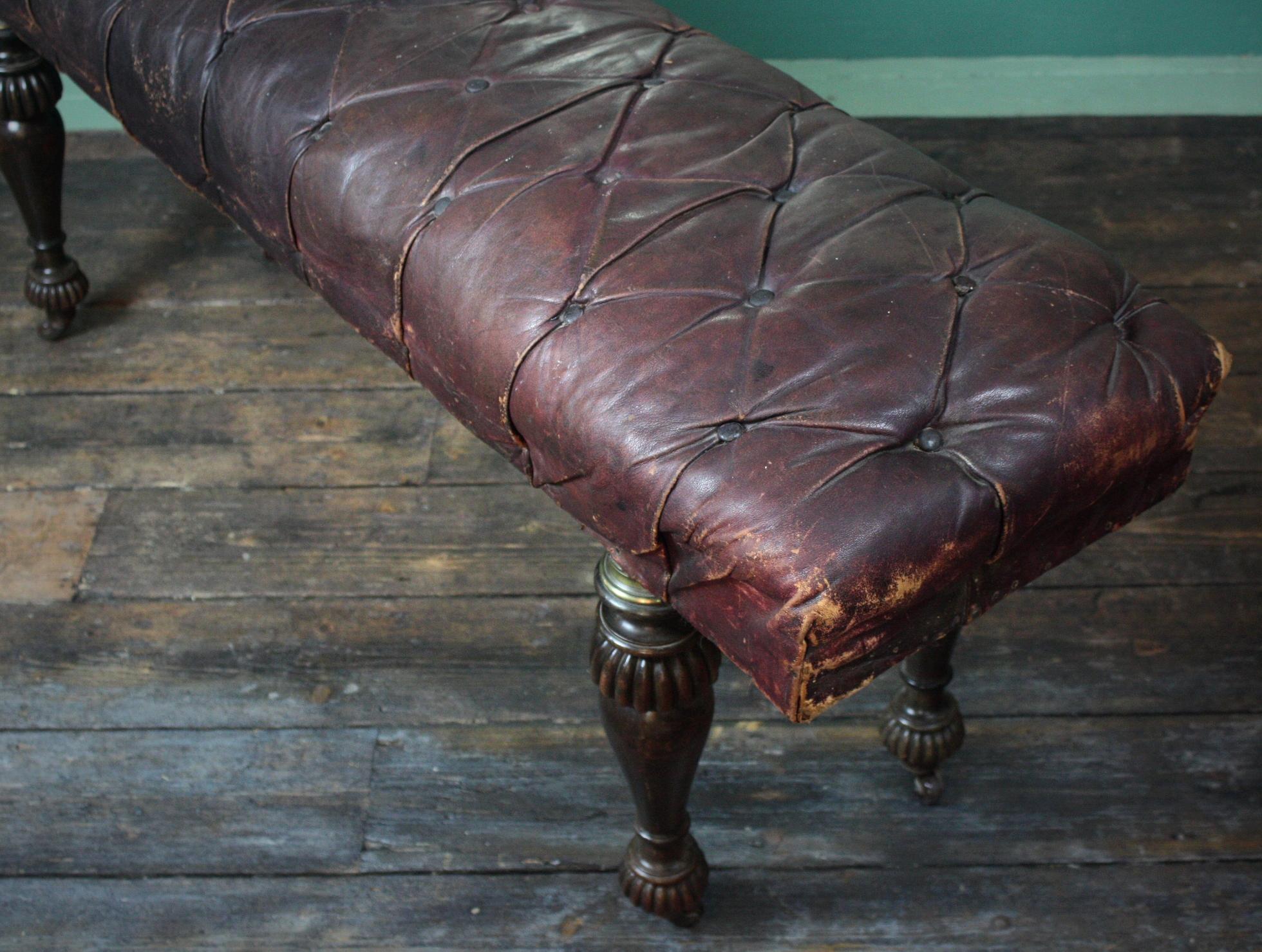 A large Moroccan leather button leather stool. 

The seat sits upon turned mahogany cup and cover legs with a brass collars and original porcelain castors.

The stool is horse hair filled and is in all round good structural sound condition with