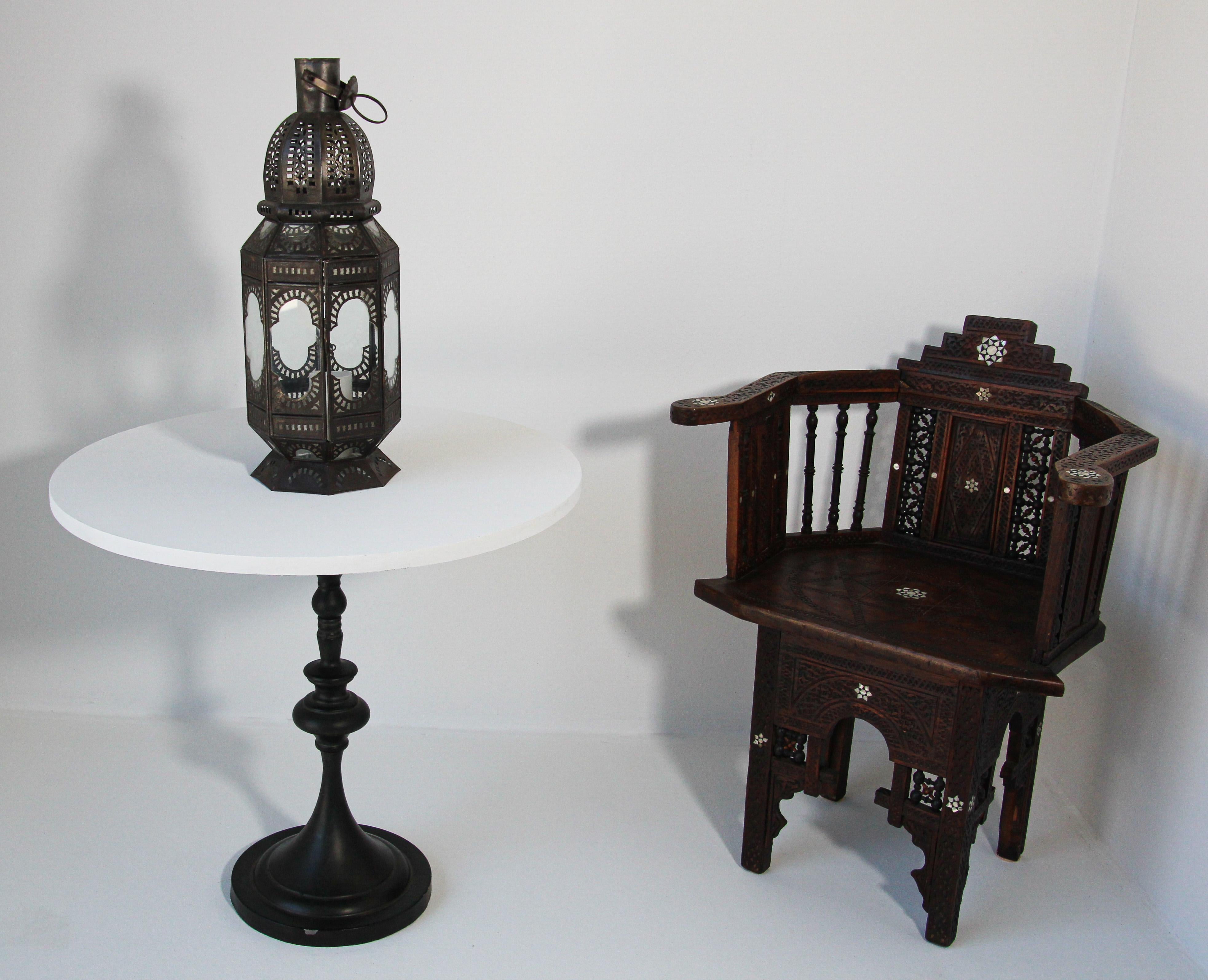 Handcrafted Moroccan clear glass lantern in octagonal shape adorned with hand-cut metal Moorish filigree designs. Hurricane candle lamp open metal work design with clear glass. There is a small door to access the inside. The lantern has a small door