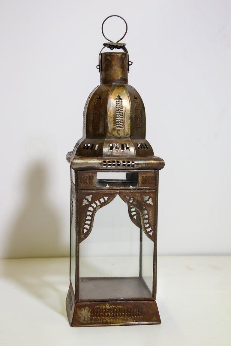 Farol marroquí artesanal de cristal transparente adornado con filigranas moriscas de metal tallado a mano.
Lámpara de vela huracán de metal con cristal transparente.
Hay una pequeña puerta para acceder al interior.
DIMENSIONES: 6ʺAN × 6ʺD ×