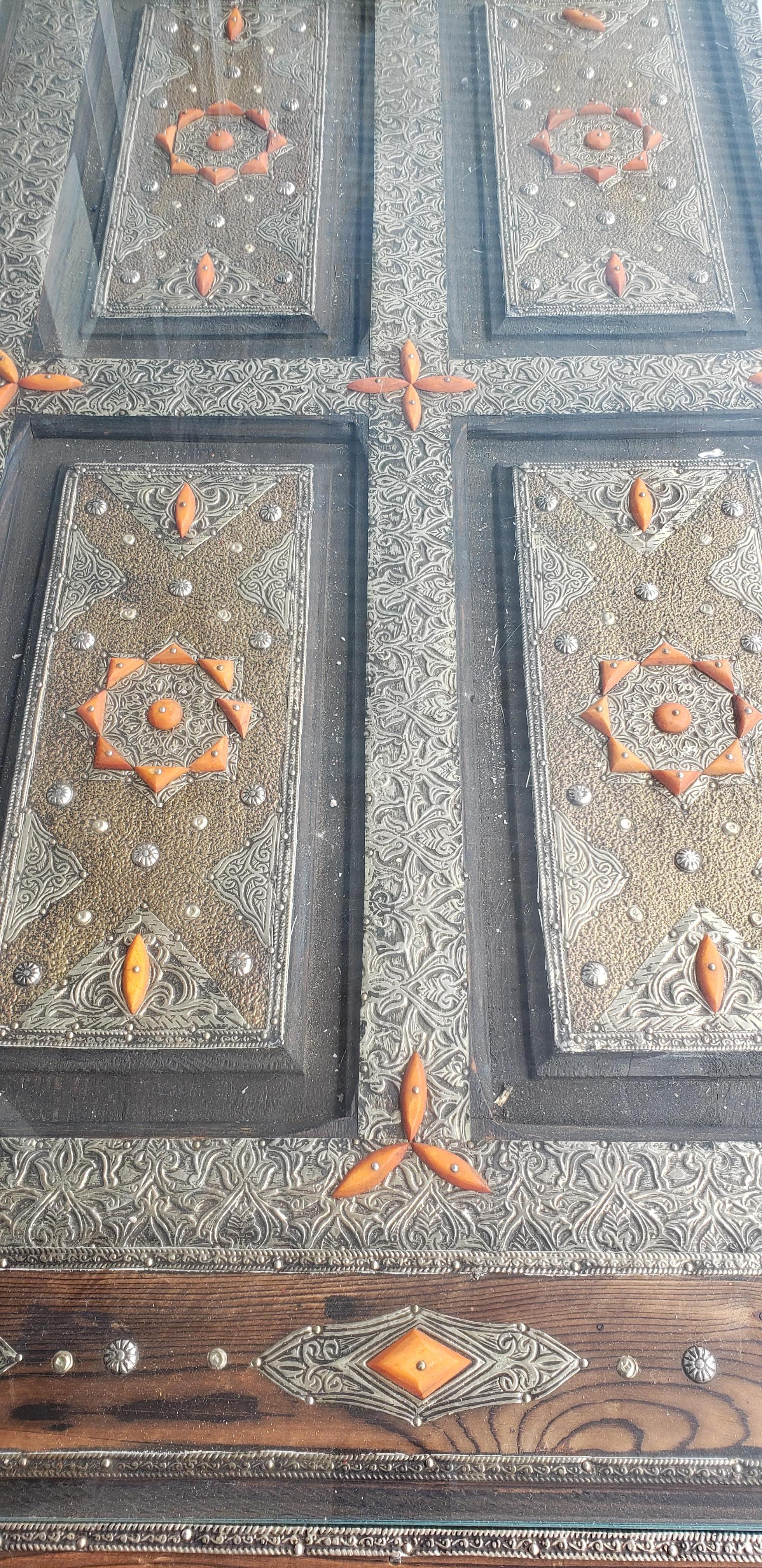 Very exotic all metal inlaid Moroccan coffee table, with mainly orange camel bone fragments throughout. With its detailed carving along the sides and the top, this beautiful table will sure be a excellent add-on to your exotic living room. It