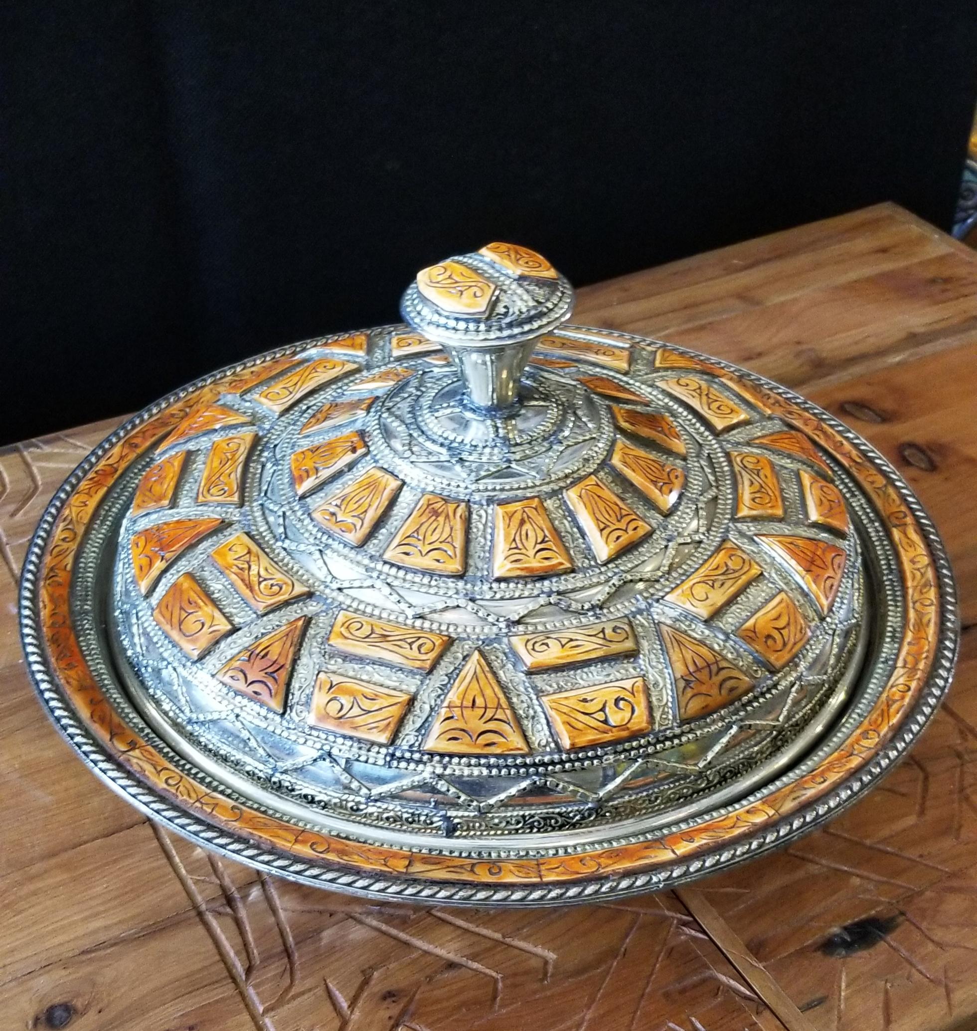 A rare or one of a kind exquisite Moroccan metal tagine, for decoration purpose only, unless used for fruits and other dry foods. Handmade. Its entire top piece along with the rim of its bottom are inlaid with camel bone and metal patterns. It would