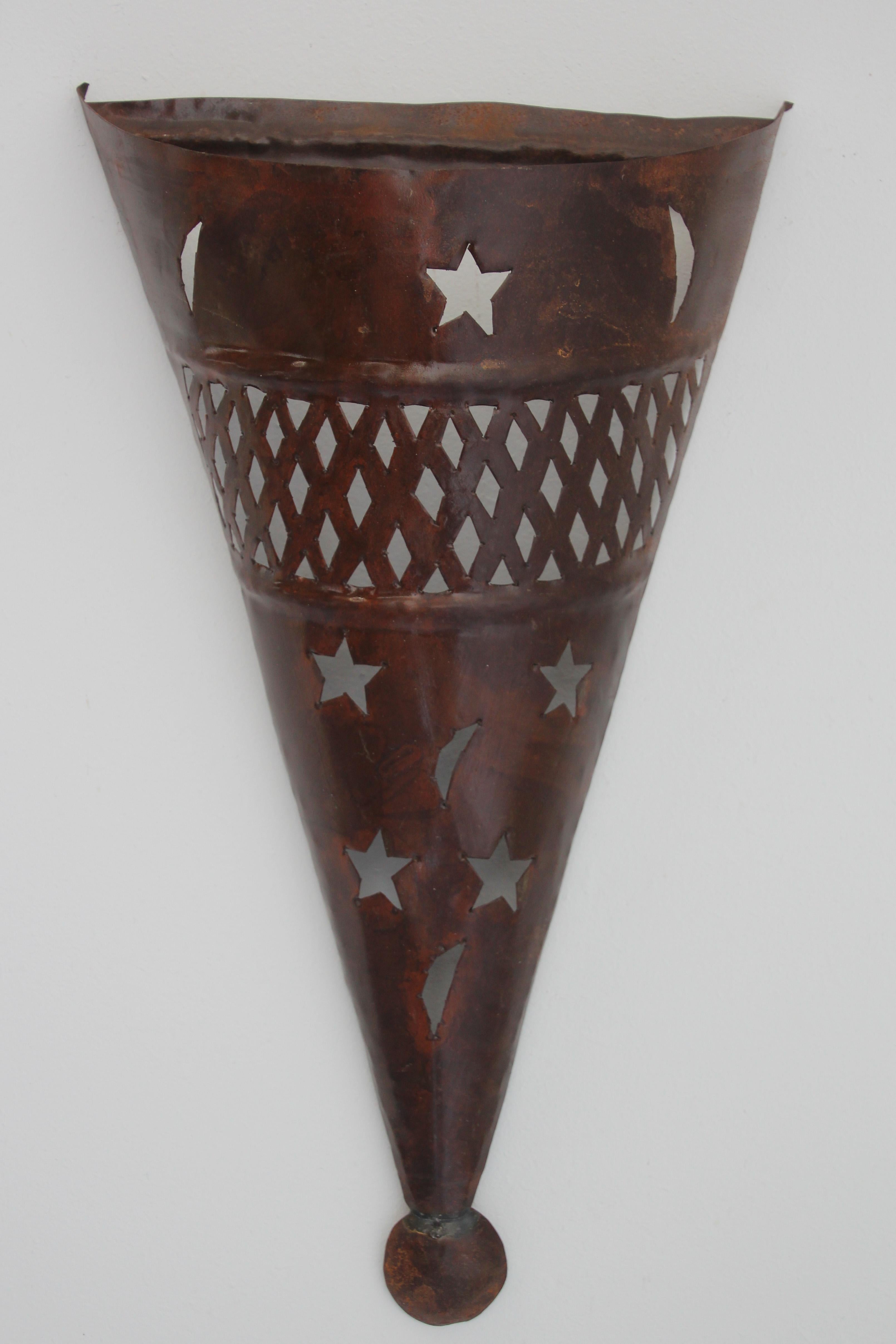 Handcrafted Moroccan Spanish style metal tole sconce shade in cone shape.
Hispano Moresque sconce shade with cutout stars and crescent moons.
Dark rust finish patina,
For use indoor or outdoor.
Not wired for electricity, shade only.
Multiple