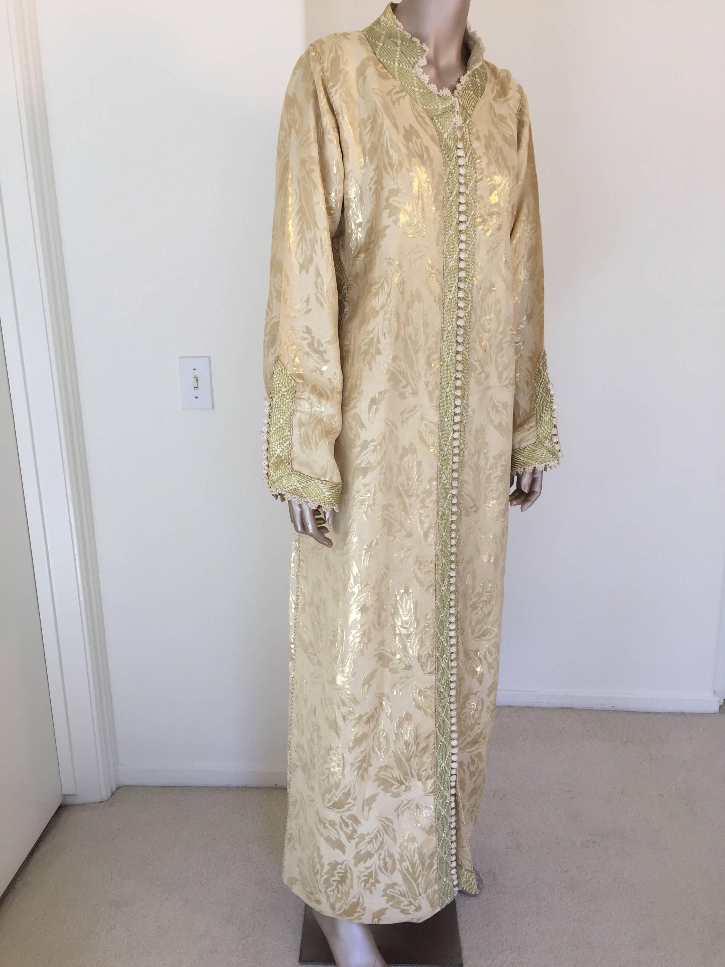 Metallic gold brocade maxi dress kaftan handmade by Moroccan artist.
Handmade vintage exotic 1970s gold metallic brocade ceremonial caftan gown from North Africa, Morocco.
The luminous brocade fabric shimmers with allover golden shine.
This maxi