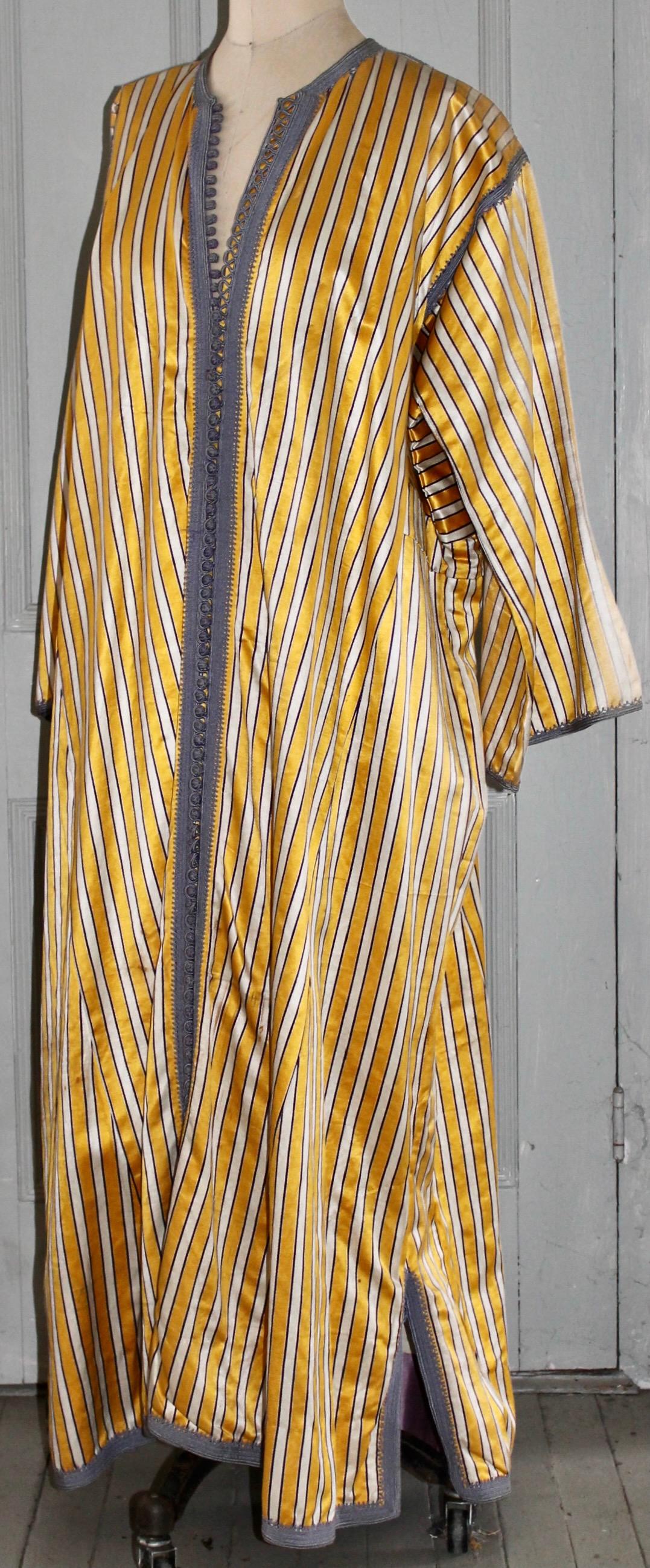 A yellow, white and grey striped silk brocade. Fully lined in cotton and silk.