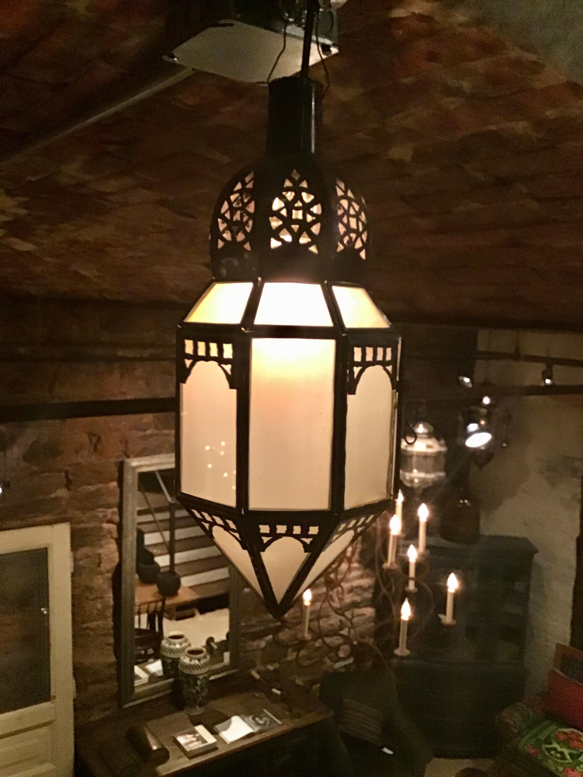 Vintage Moroccan lantern with milk/frosted glass and beautifully carved designs. Lantern has a little door on the side to access the inside. Adds charm to any space.