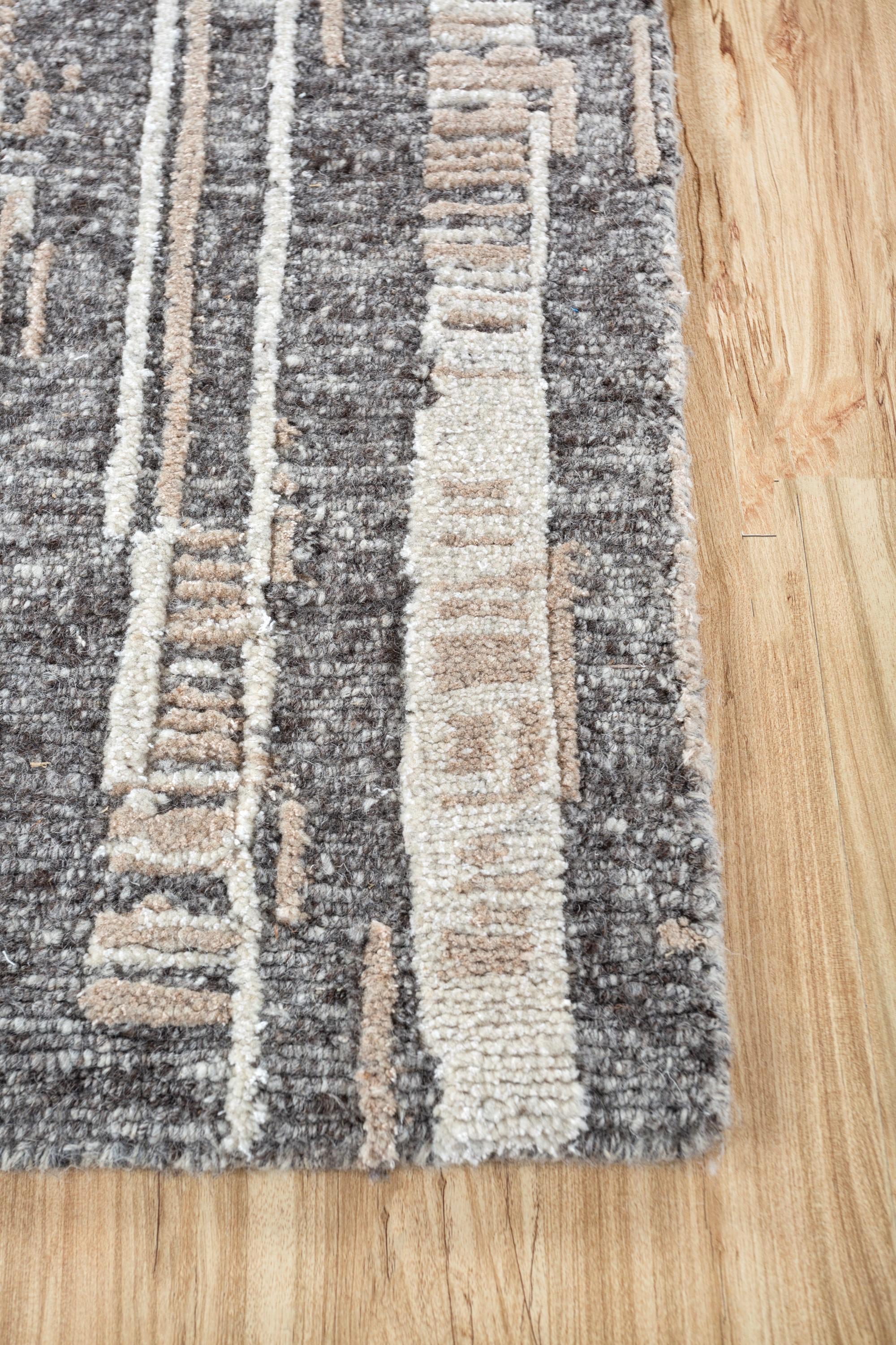 Imagine stepping into a realm of timeless elegance with our hand-knotted rug. This masterpiece  seamlessly weaves Moroccan charm into a modern aesthetic, creating an eclectic dance of patterns. Crafted with an all-wool construction, the modern rug