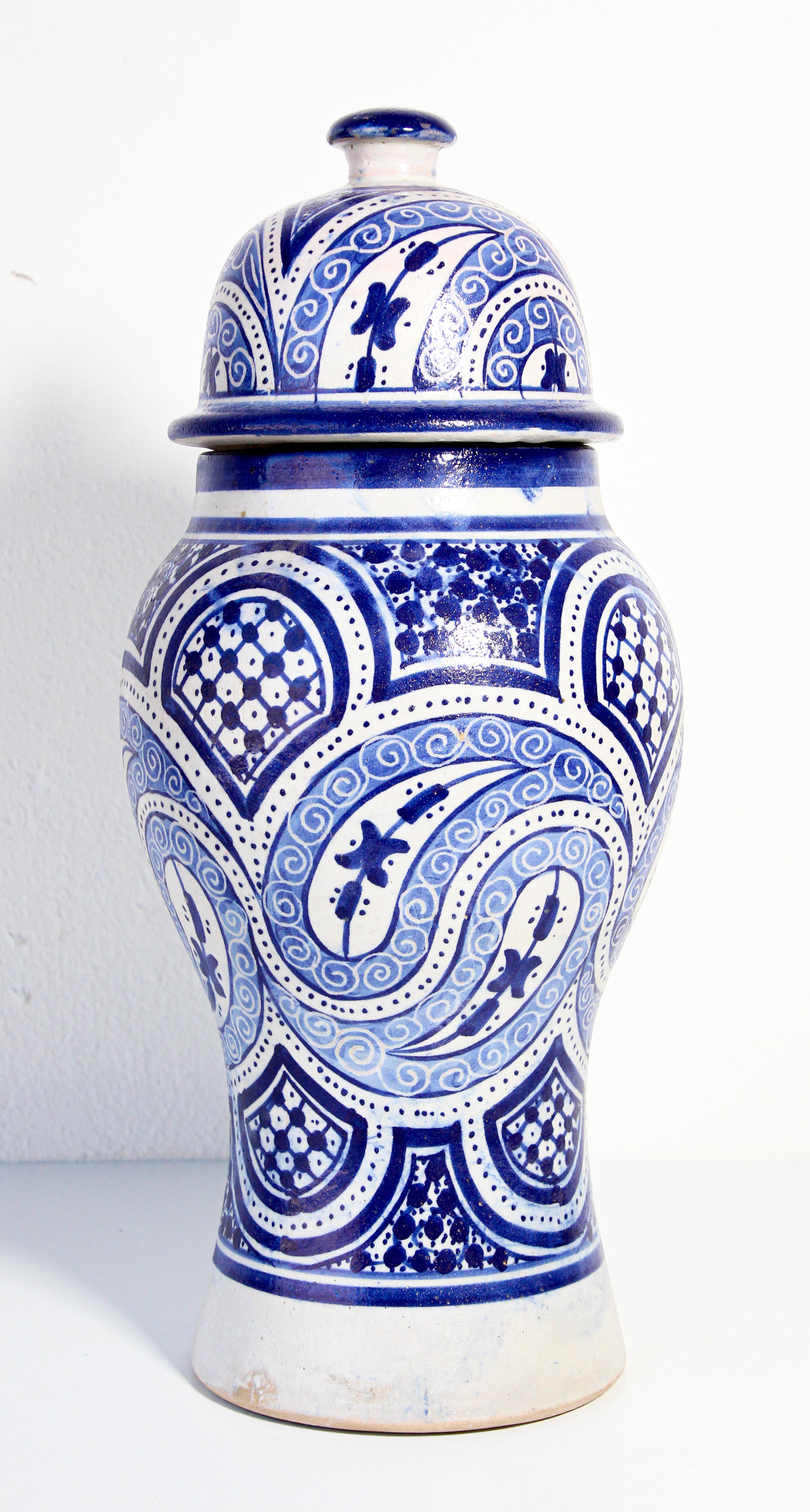 Moroccan glazed ceramic urn with lid from Fez.
Moorish style ceramic handcrafted decorative jar hand painted floral and geometric design.
Royal blue and ivory color Moorish design.
Size: 16 in. height x 7 in. diameter.
Vintage handcrafted decorative