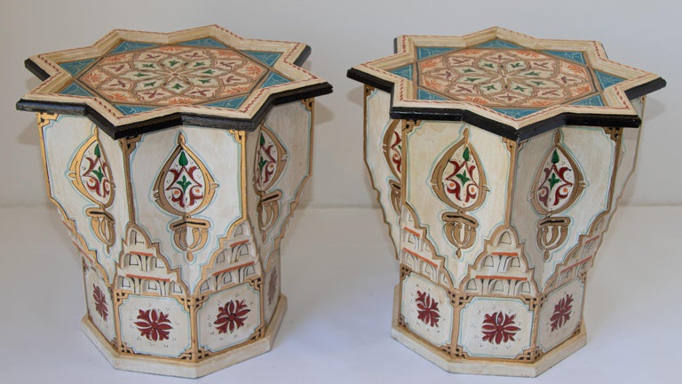 Pair of Moroccan colorful ivory color hand painted and carved side occasional tables with Moorish designs.
Vintage Moroccan Pedestal tables in ivory background with multicolored floral and geometric designs.
Very decorative Moroccan tables with
