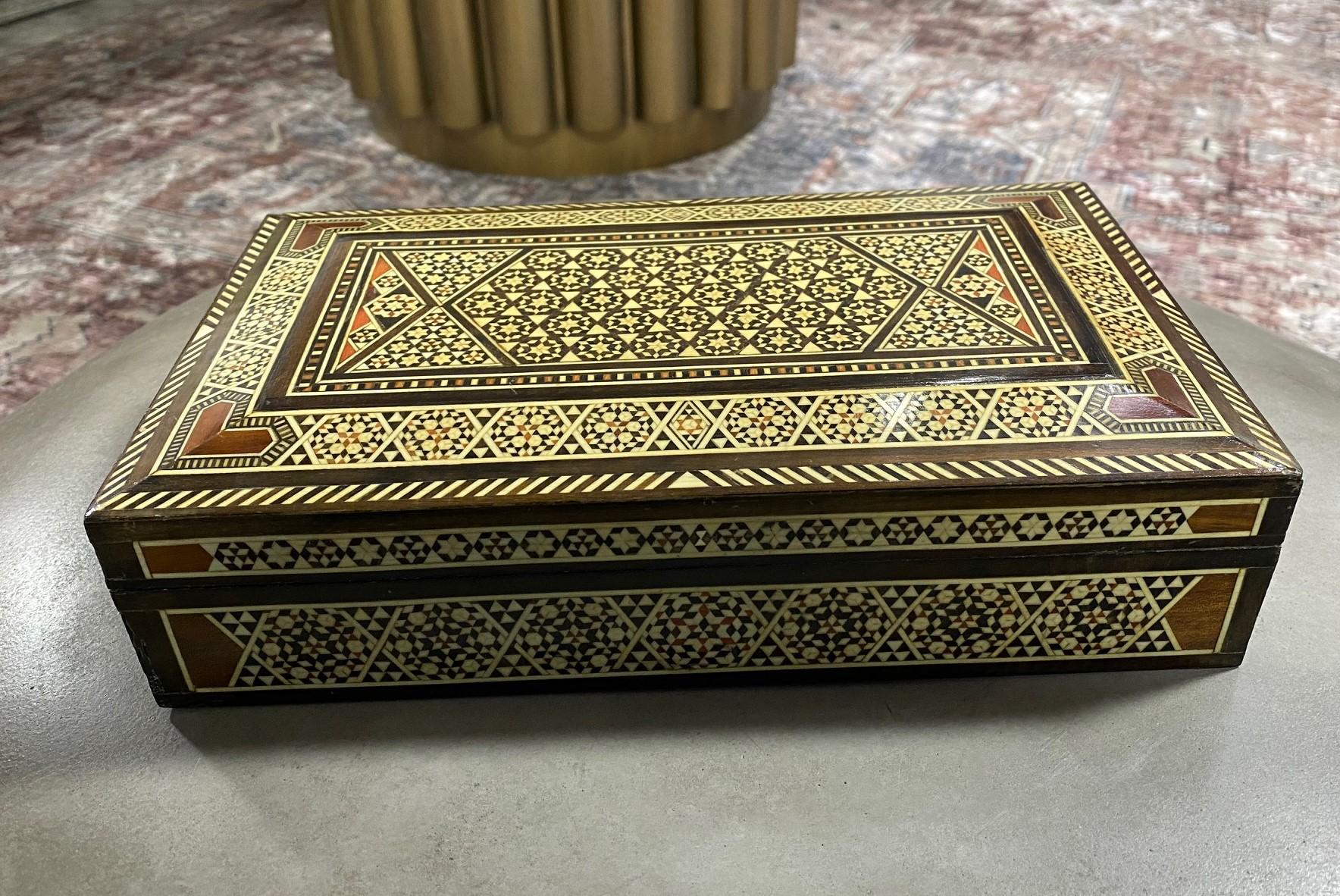 Stunning mosaic design, this intricate wood box is made from multiple micro pieces of wood with some possible bone inlays. Gorgeous craftsmanship. A true work of art.

Would be a great addition to any decorative art box or jewelry box collection