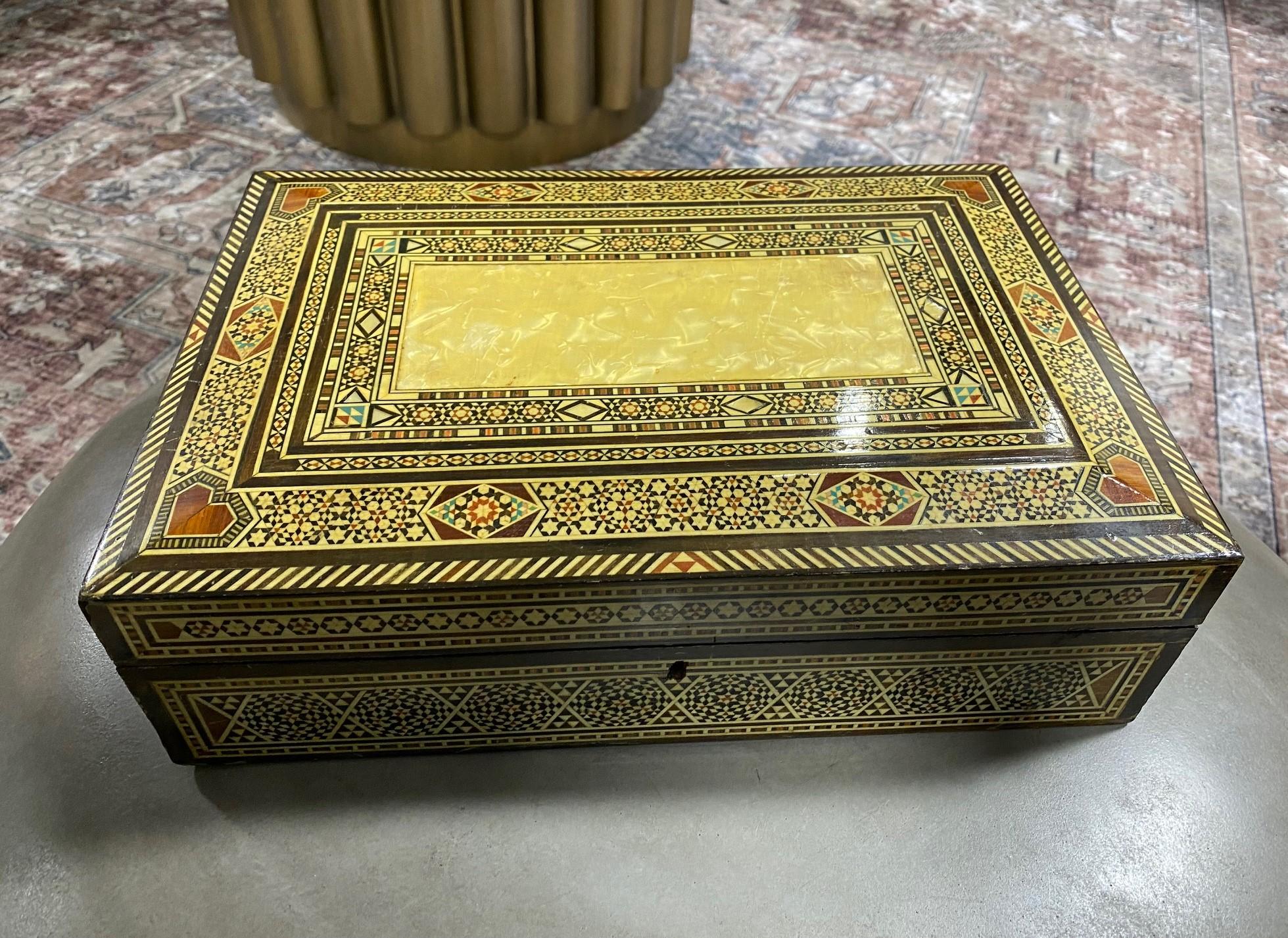 Stunning mosaic design, this intricate quite large wood jewelry box is made from multiple micro pieces of wood, mother of pearl with some possible bone inlays. Gorgeous craftsmanship. A true work of art. 

Small key included. 

Would be a great