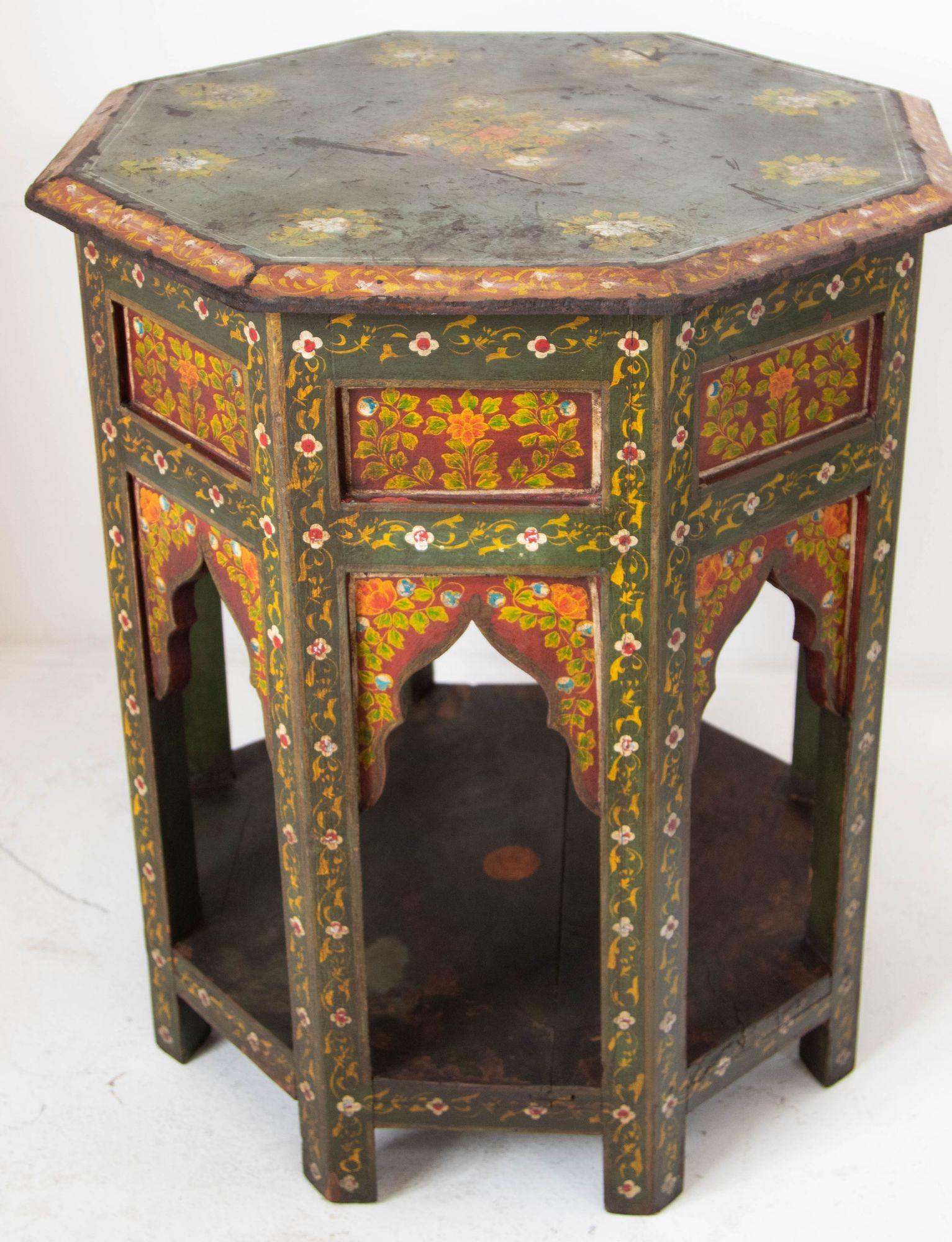 Large vintage Moroccan Moorish Spain Octagonal side table hand painted wood in dark green and red floral design.
Heavy large Moroccan Moorish hand painted teak side table in distressed antique look.
Moroccan vintage octagonal table hand painted on
