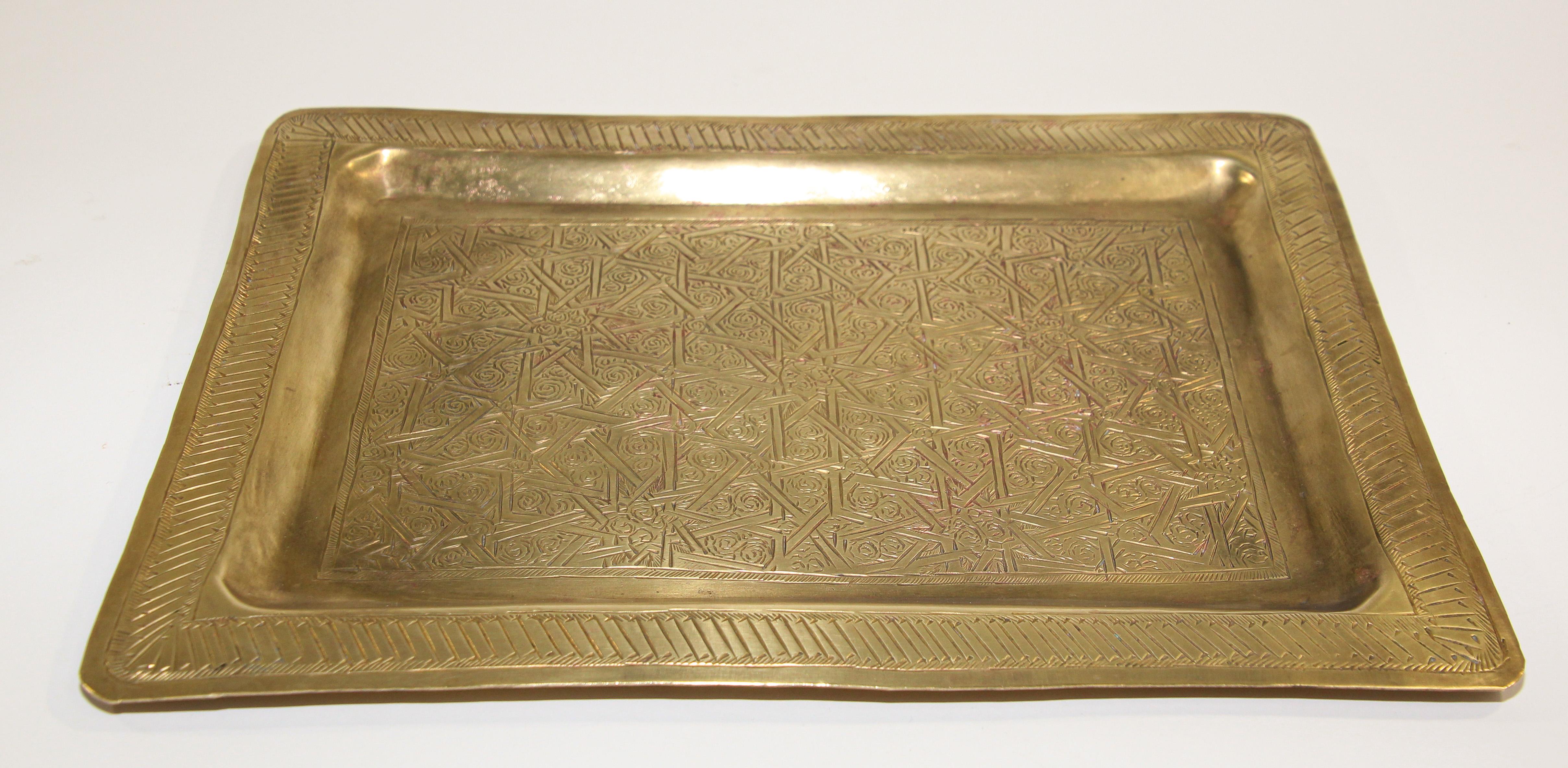 Moroccan Moorish rectangular brass tray with fine delicate geometrical designs.
Could be used as a serving tray, or decorative wall hanging.
Fine handcrafted hammered and chased Moorish star designs.
Hand made in Morocco, circa 1940's.