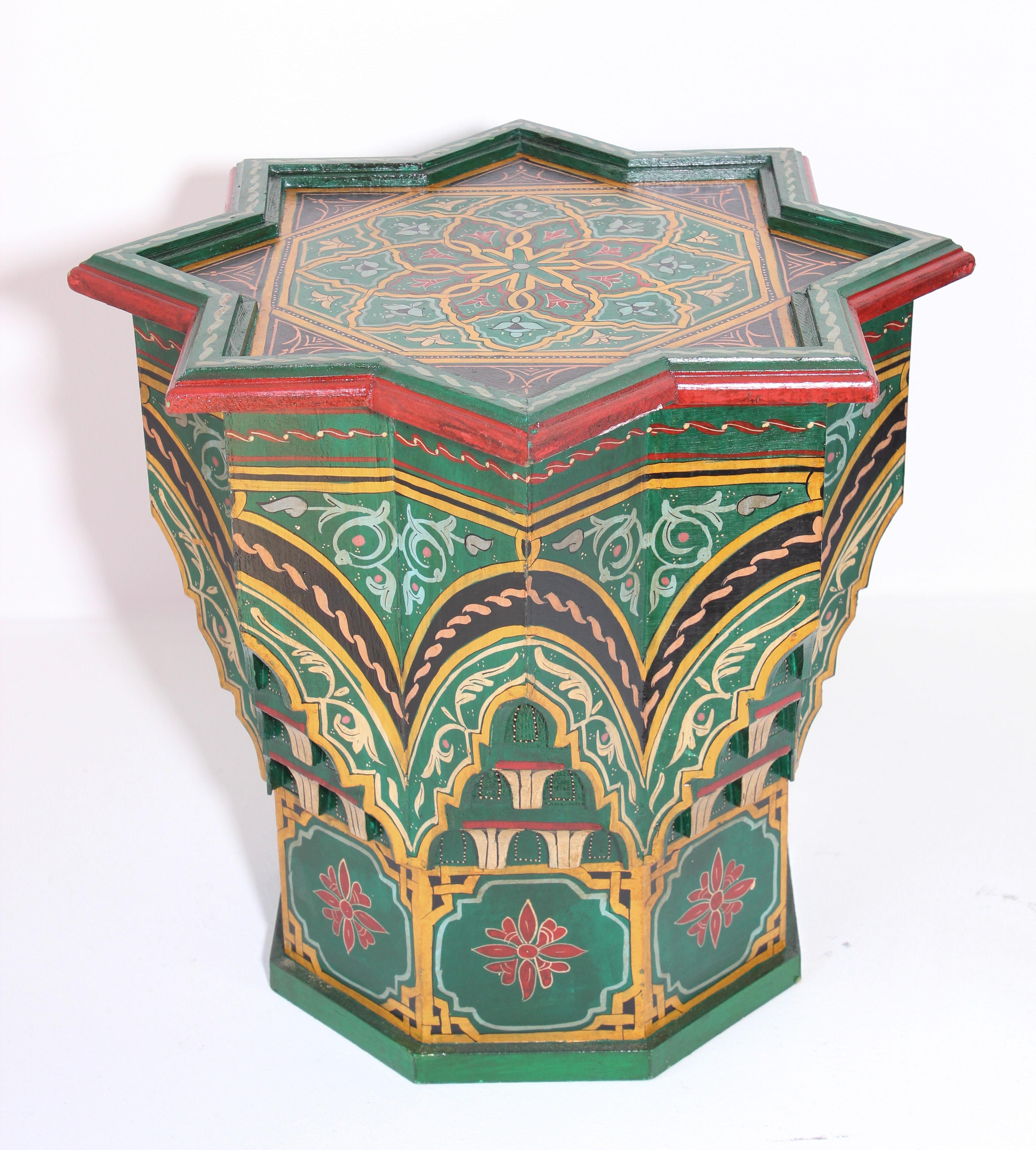 Moroccan colorful Green color hand painted and carved side occasional table with Moorish designs.
Vintage Moroccan side table in green background with multicolored floral and geometric designs.
Very decorative fine artwork on a star shape.
Hand