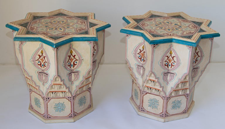 Pair of Moroccan colorful ivory color hand painted and carved side occasional tables with Moorish designs.
Vintage Moroccan Pedestal tables in ivory background with multicolored floral and geometric designs.
Very decorative Moroccan tables with