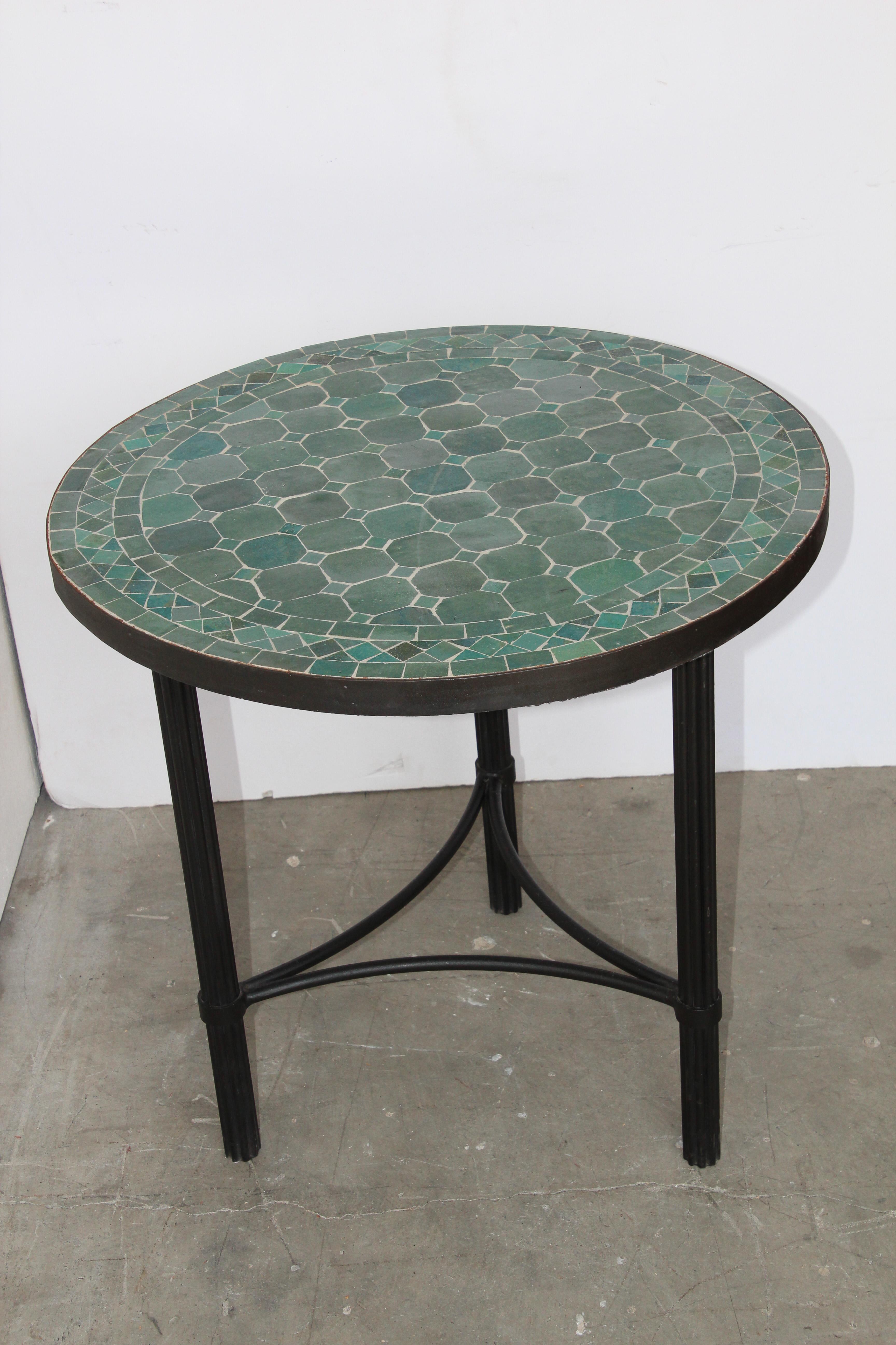 Moroccan mosaic tiles side table on iron base.
Handmade by expert artisans in Fez, Morocco using reclaimed old glazed green colors tiles inlaid in concrete and making beautiful geometrical designs, the iron base is black color.
These tables could