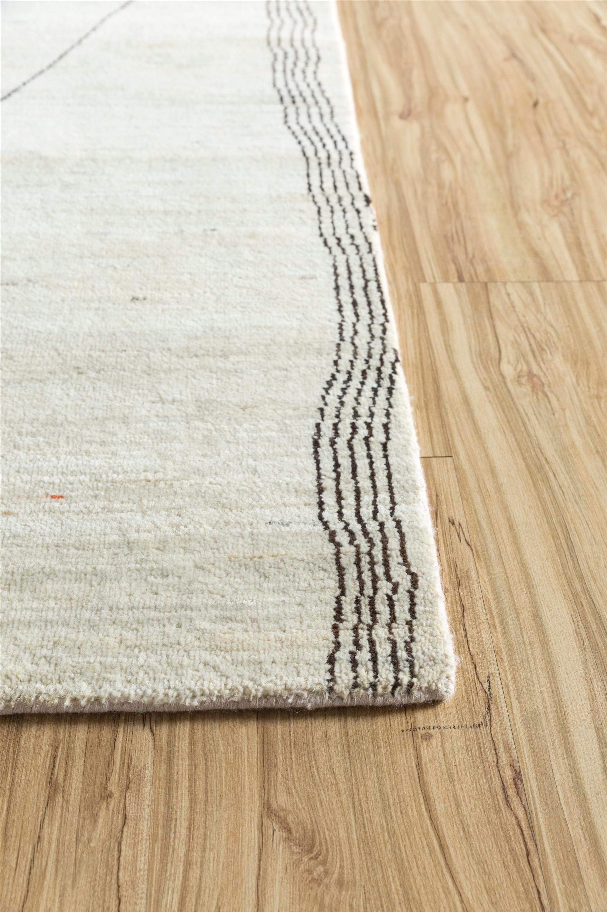 Immerse your living space in the timeless allure of this hand-knotted Moroccan-inspired rug, a testament to the seamless blend of tradition and modernity. Crafted from sumptuous, all-natural wool, the rug's eclectic patterns, reminiscent of Moroccan