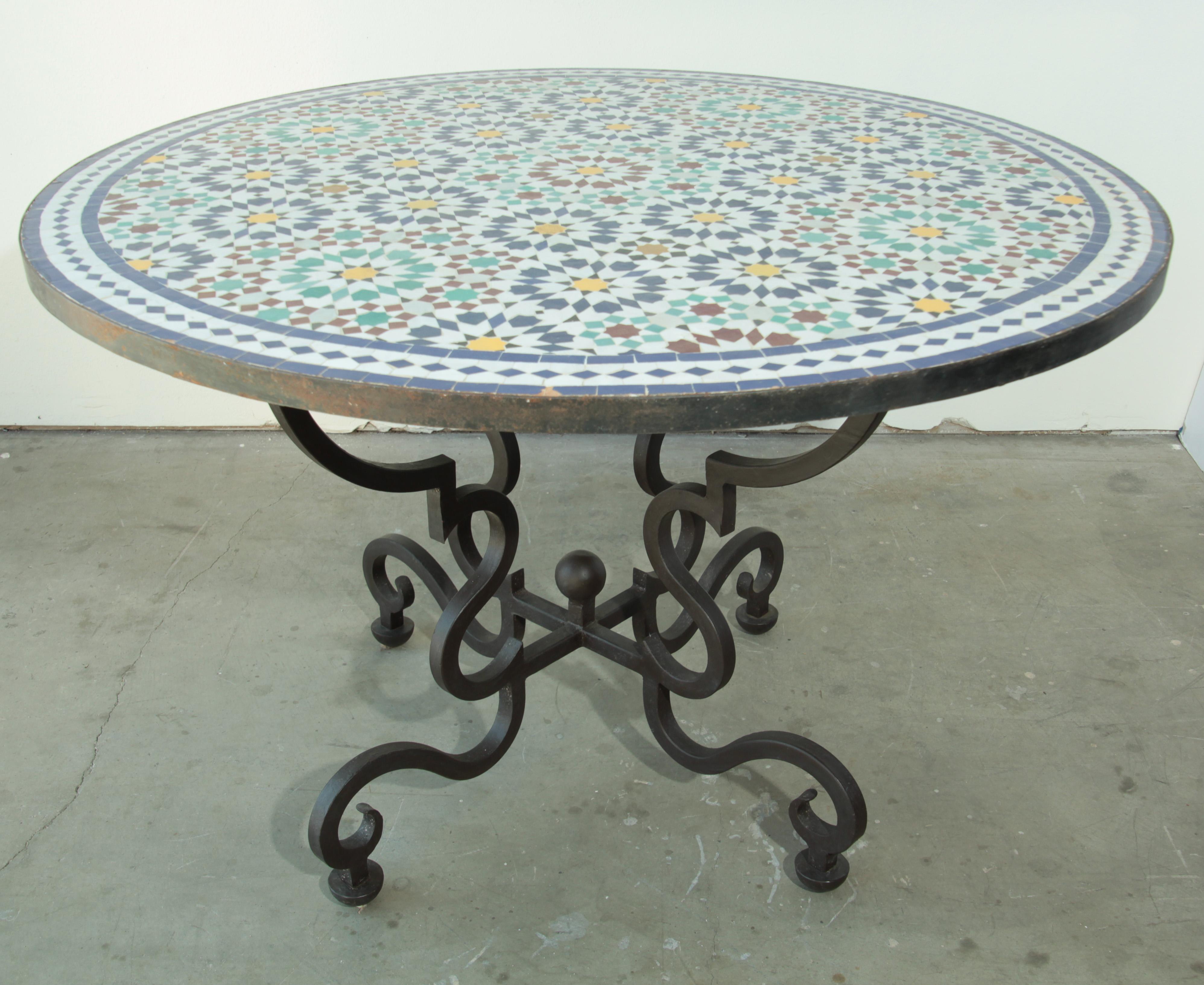 Moroccan round mosaic tile table delicately handcrafted by expert artisans in Fez, Morocco, using reclaimed old glazed tiles inlaid in concrete with traditional Islamic Moorish geometrical design in white, blue, red, green and aqua colors.
Moroccan
