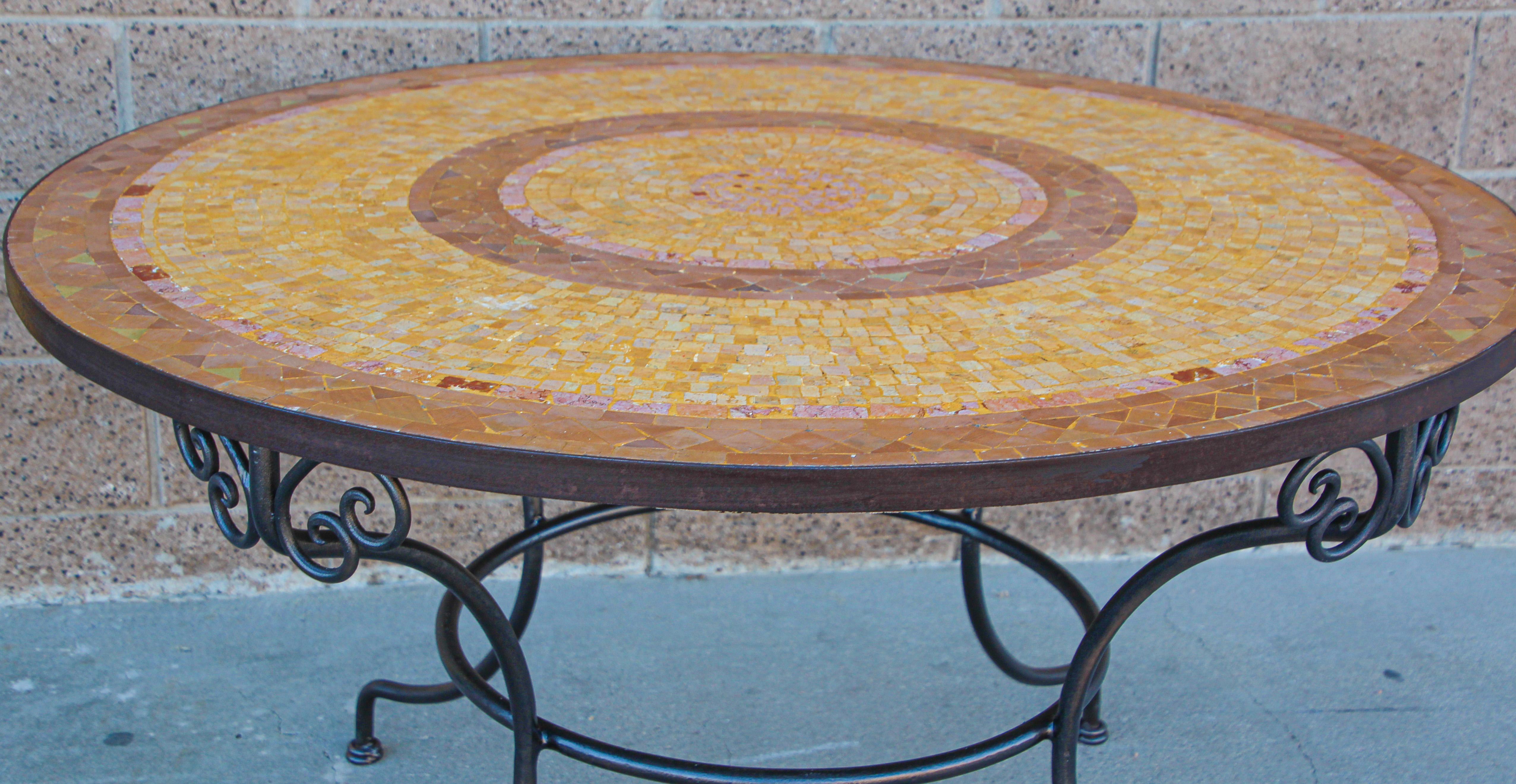 A inlaid round stone Moroccan mosaic tile tabletop on a wrought iron base.
Handcrafted in Morocco could be use indoor or outdoor.
Dimensions: Height: 29.5 in (74.93 cm)Diameter: 47 in (119.38 cm)
Spanish Moorish garden dining mosaic table in the