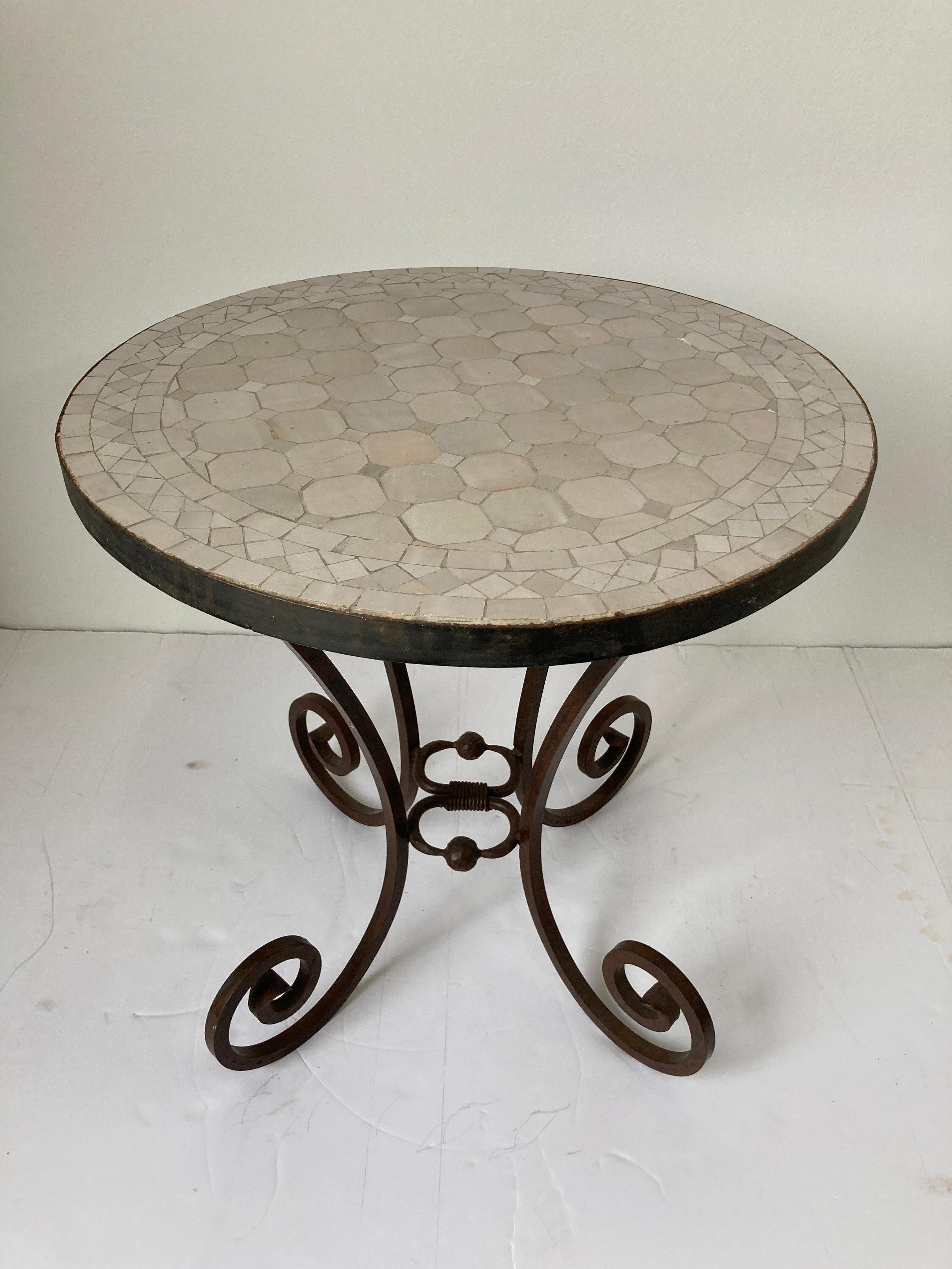 Moroccan mosaic tile side table on iron base.
Colors are ivory, off white, beige.
Handmade by expert artisans in Fez, Morocco using reclaimed old glazed teal color tiles inlaid in concrete using reclaimed old glazed tiles and making beautiful