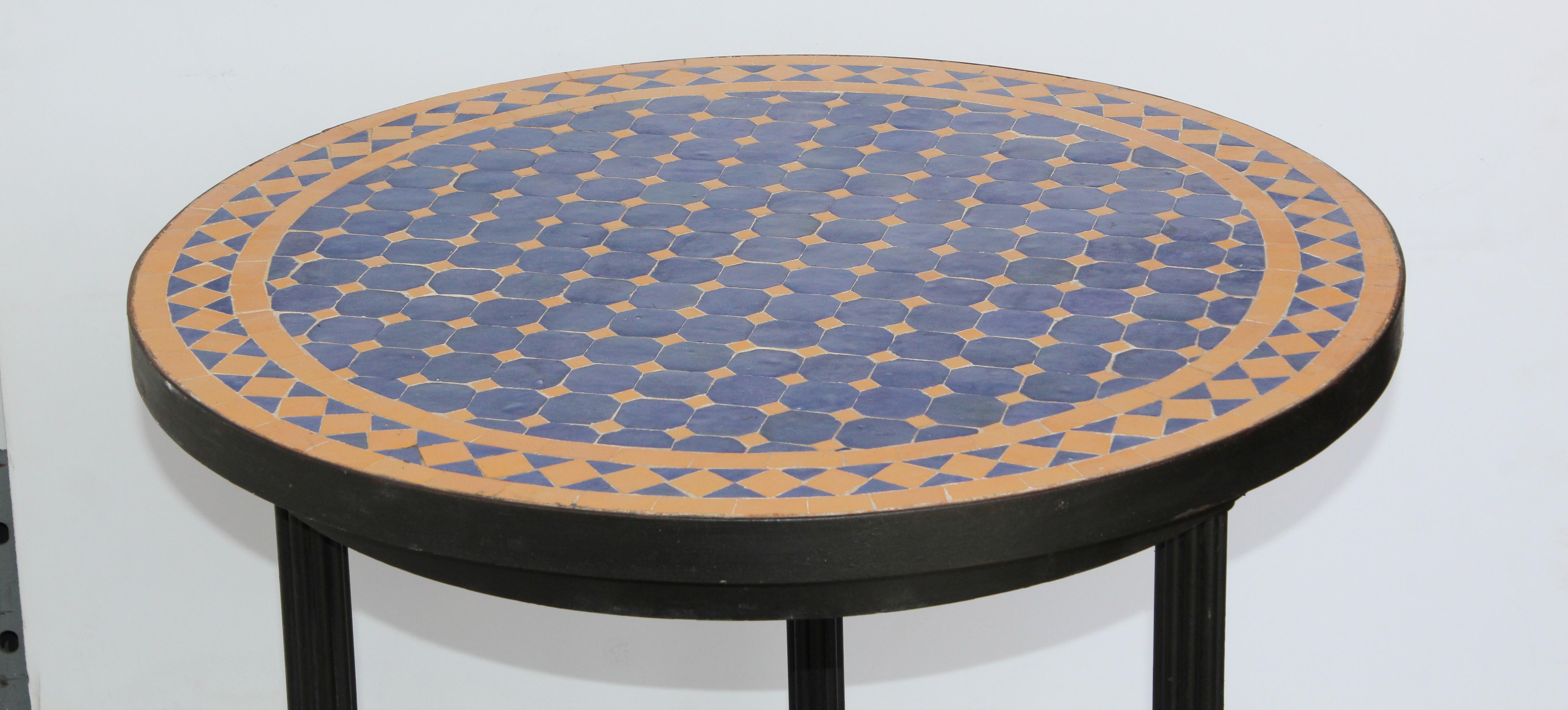 Moroccan mosaic tiles side table on iron base.
Handmade by expert artisans in Fez, Morocco using reclaimed old glazed cobalt blue and yellow colors tiles inlaid in concrete using reclaimed old glazed tiles and making beautiful geometrical designs,