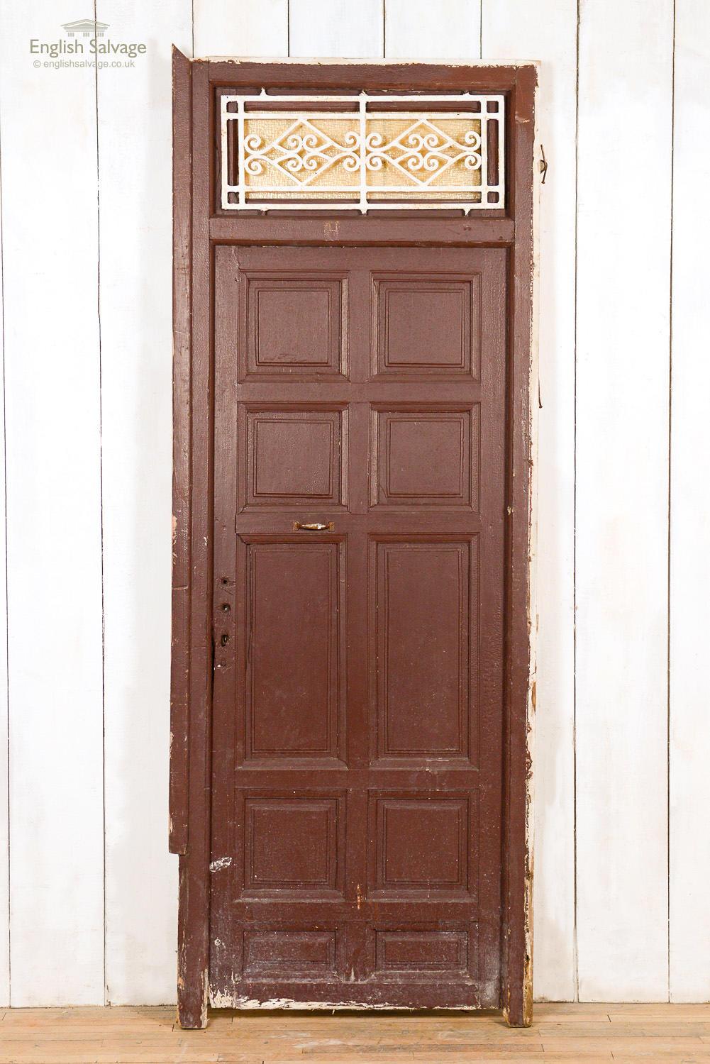 Reclaimed soft wood door with ten fielded panels and a frame with metal grille. Overall size below, the door itself is 73cm wide x 186cm high. Wear and tear plus handle, lock and nail holes present.
