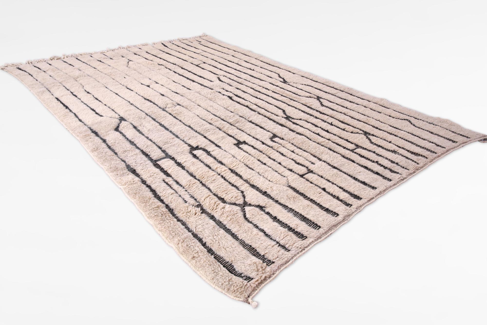 This modern-style, original Mrirt rug is handcrafted by talented artisans in the Khenifra region of the Atlas Mountains in Morocco. Here, groups of women continue the ancient tradition of hand-weaving on traditional vertical looms to produce these