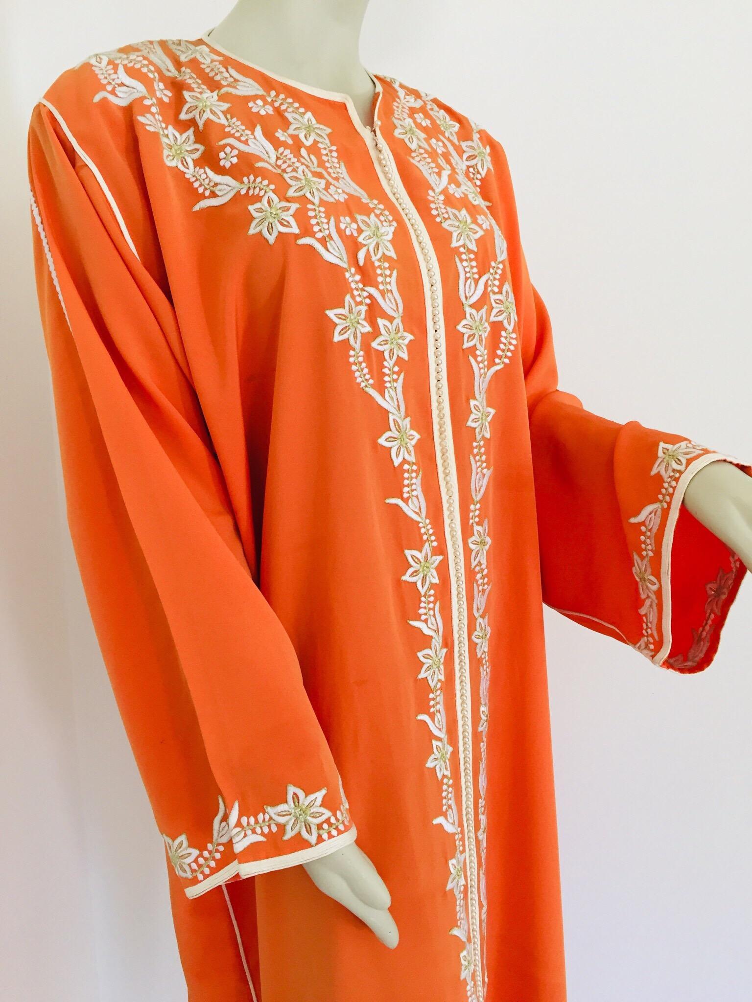 Elegant Moroccan caftan orange color embroidered with gold trim,
circa 1970s.
This long maxi dress kaftan trim is embroidered and embellished with pearls entirely by hand.
One of a kind evening Moroccan Middle Eastern gown.
The kaftan features a
