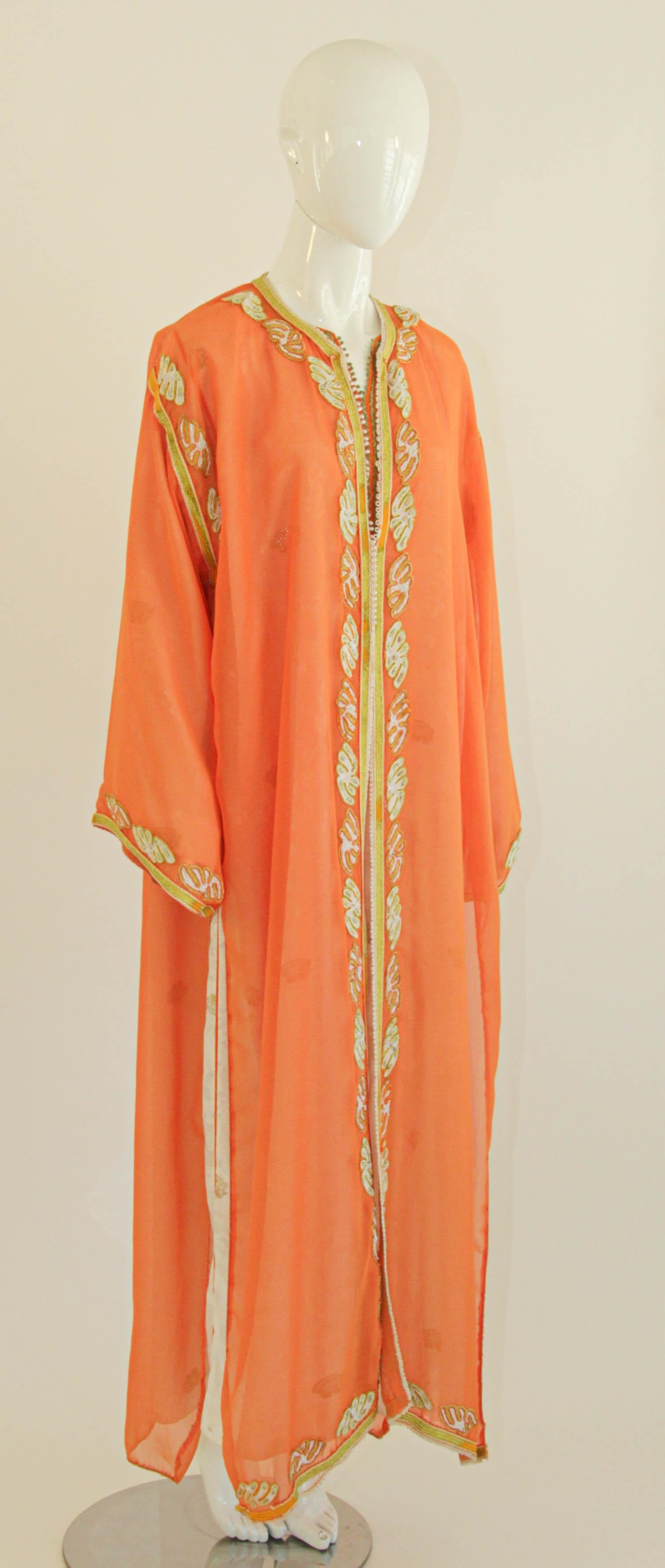 Elegant Moroccan caftan in orange silk georgette see through chiffon.
A beautiful pick for summertime occasions, this kaftan maxi dress is crafted from silky, feather-light see through fabric.
circa 1980s.
This long maxi dress set kaftan is