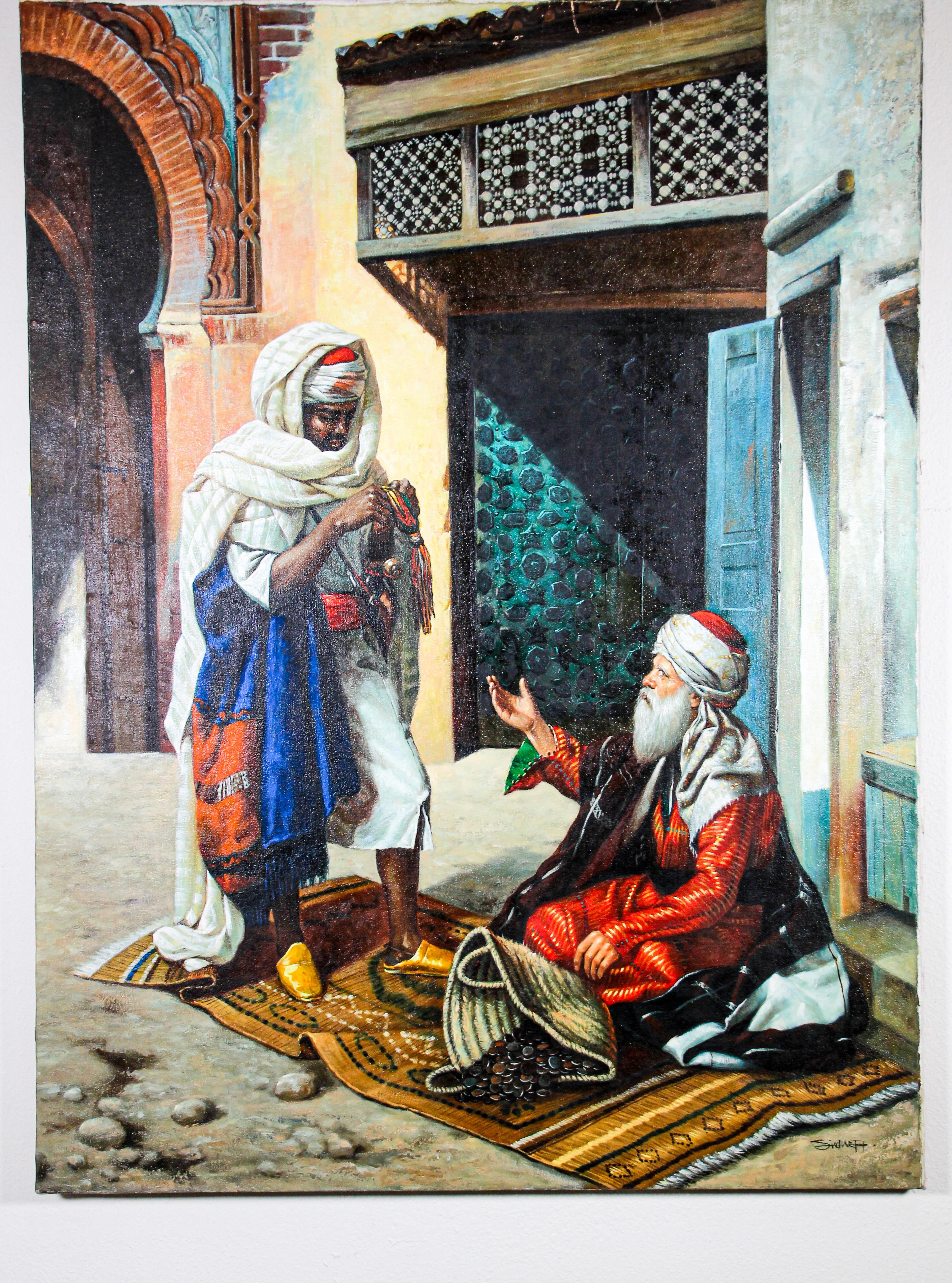 Moroccan Orientalist oil on canvas painting of a 19th century Moroccan market scene with an old men seating on a carpet selling old coins and a Moorish men 
 standing and checking the goods.
The background depict an old house with wooden mucharabie