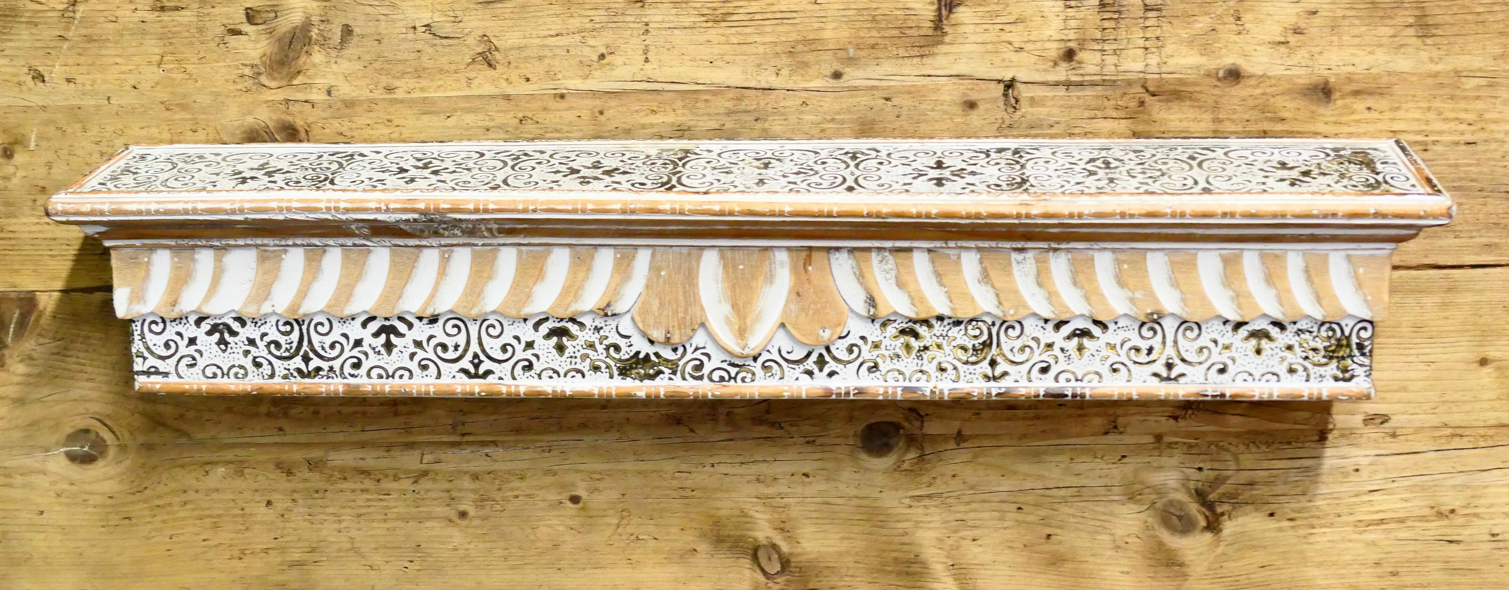Moroccan Painted Folk Art Wall Shelf
This charming little wall hanging shelf is in the Islamic style and hand painted  
The shelf is 5” high, 30” wide and 5” deep
HW123
