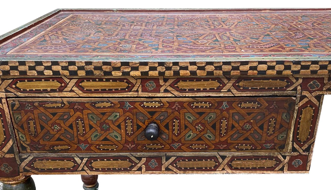 Moroccan painted wood desk. Painted desk with two drawers and painted medallions. Handmade and hand painted. Measures: 68.5” L x 23” W x 29.2” H.
