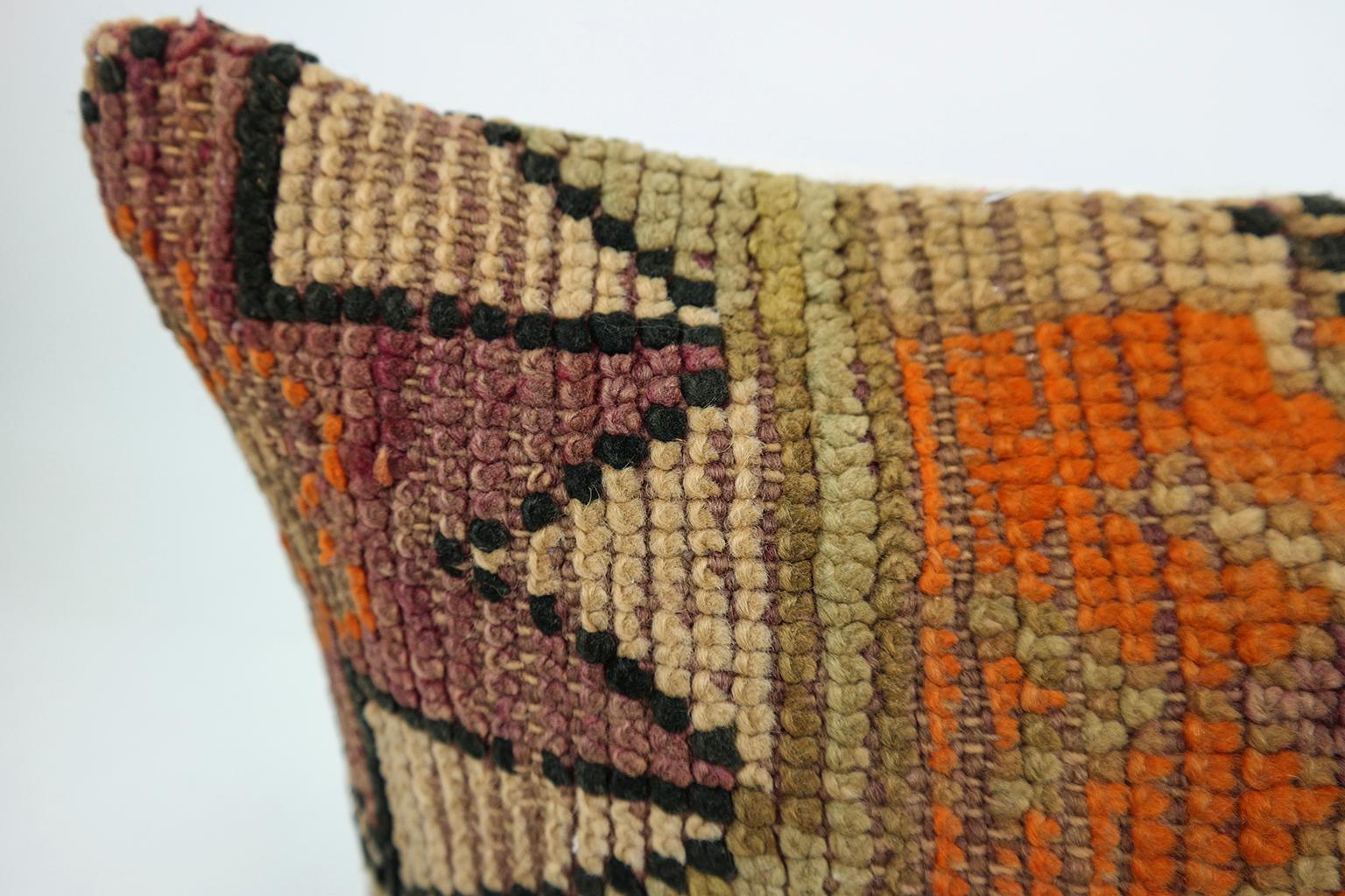 Cushion custom-made from a more than 50 years old Moroccan rug, searched and selected by ourselves. This pillow is a one-of-a-kind with beautiful shades of aubergine, orange and olive green. The beauty of our pillows is that they are timeless and