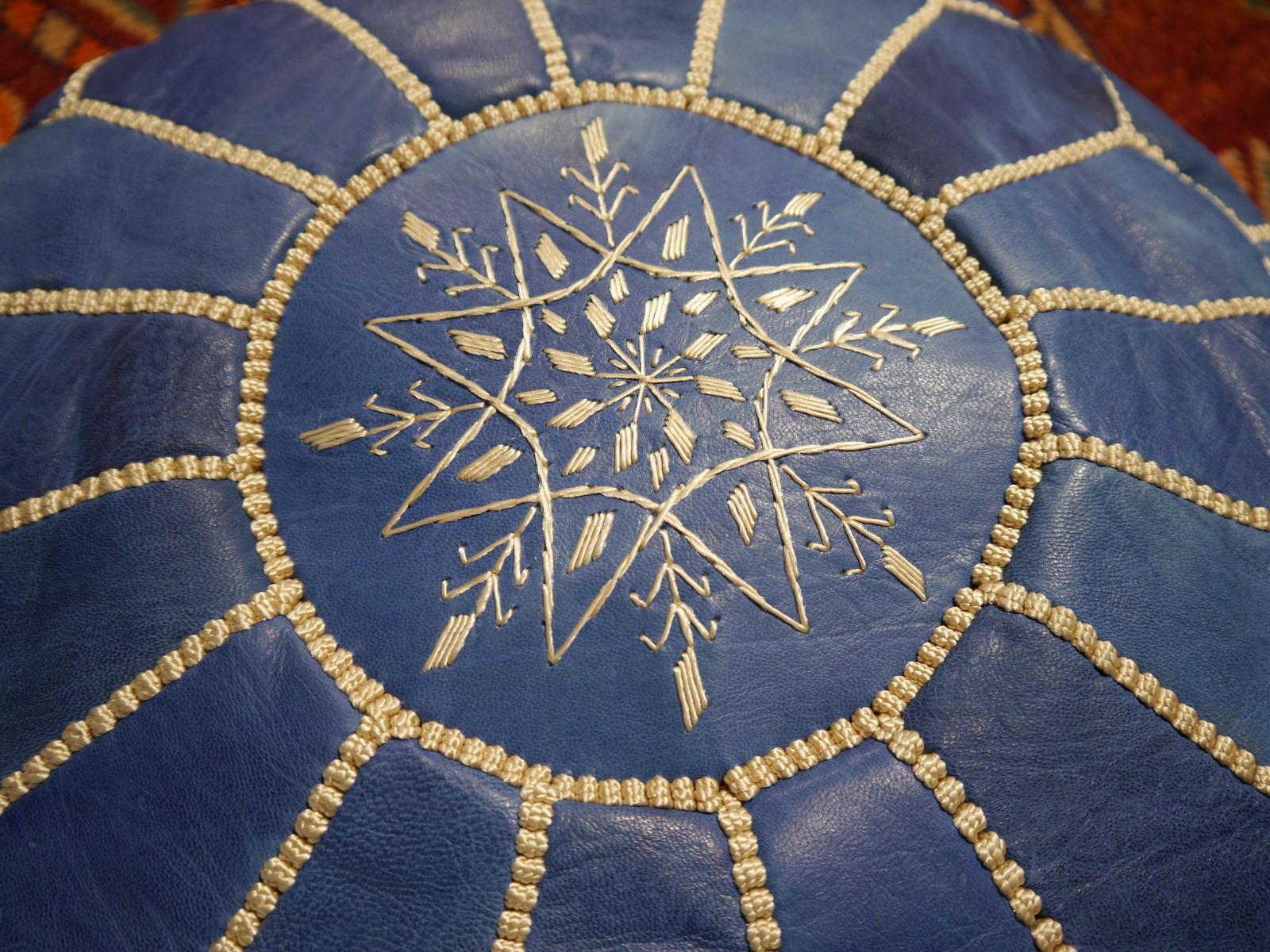 A beautiful handcrafted Moroccan blue leather ottoman pouf
 
Construction
This pouf was handcrafted by Morrocan Artisians. It consists of high quality leather with embroideries and tribal motive on top. This Item will be delivered stuffed with