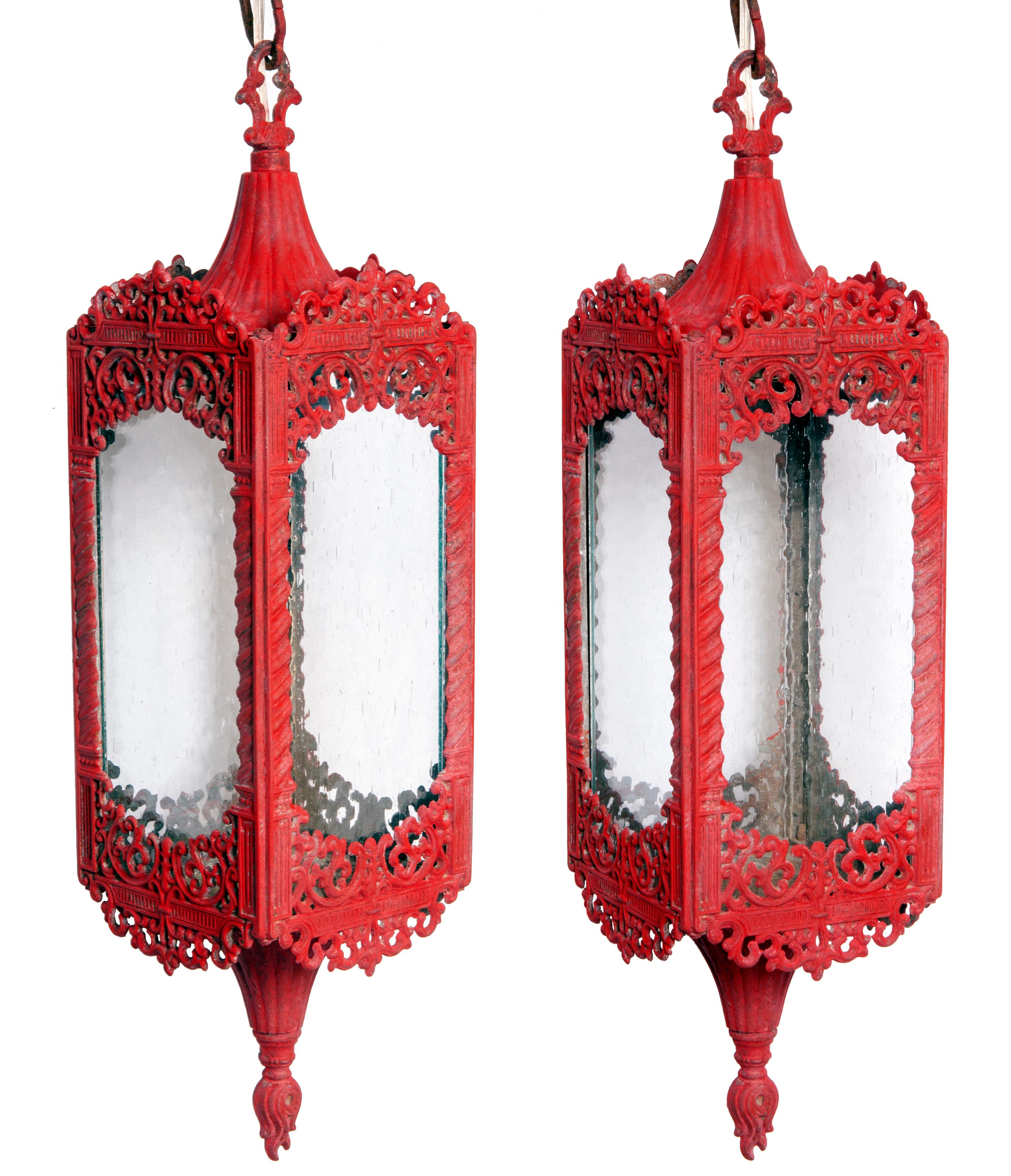 Mid-century Moorish style pendant lanterns with clear seeded glass panels & original chain. 
Lanterns are available in China red or matte black.
The lanterns feature intricate metal scroll work.
Restored & rewired with in line switch & plug for