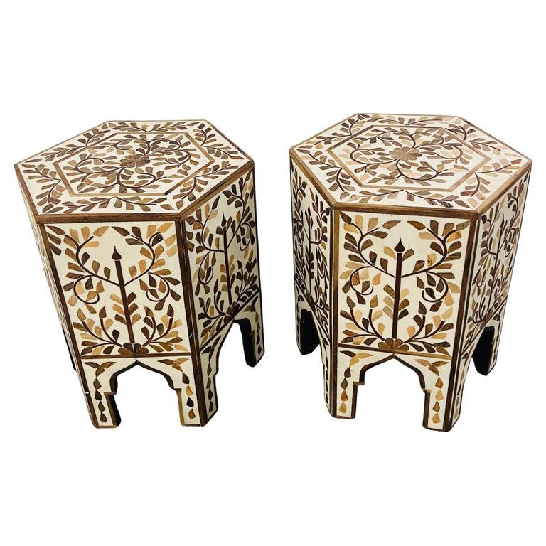 An exquisite pair of Moroccan side or end table featuring an hexagonal shape. The handmade tables are finely decorated in leaves Pattern and beautiful arches, a staple of the moorish timeless architecture and design. Hand made of resin in an off