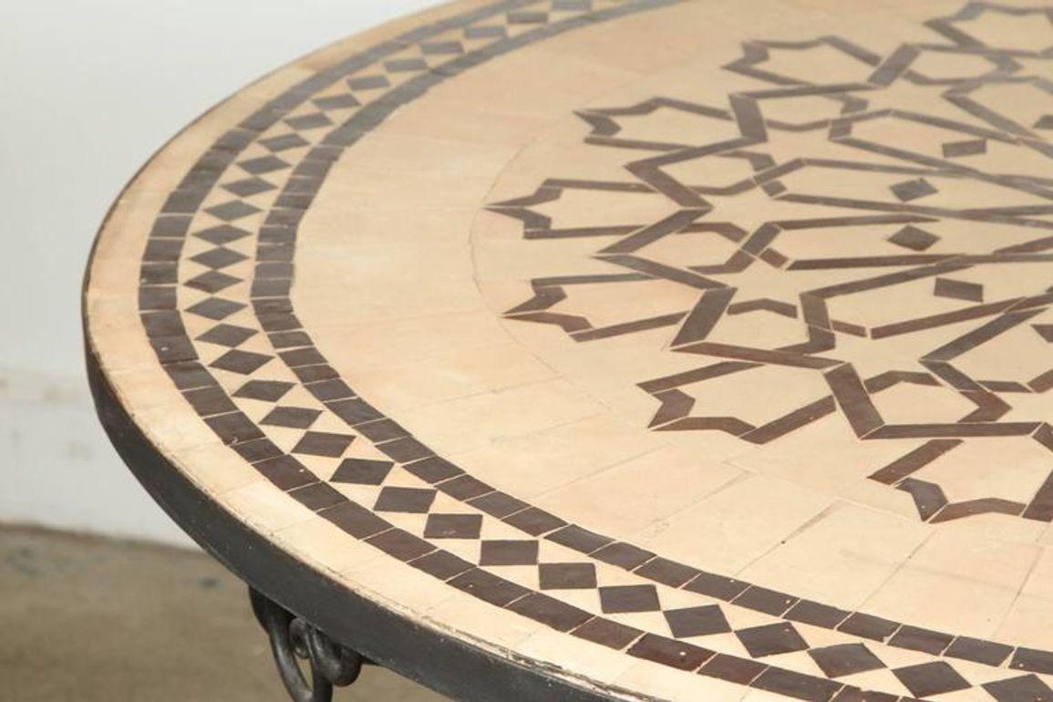 Handcrafted round Moroccan outdoor mosaic tile table 47in diameter on iron base.
Classic and elegant Moroccan outdoor mosaic tile table sit on a black wrought iron base.
Handmade in Morocco, the artisans from Fez used the classic chiseled design in