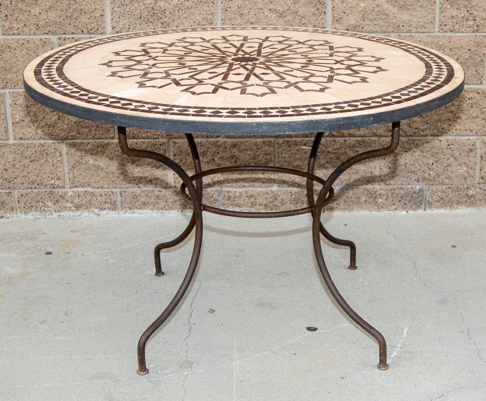 Handcrafted round Moroccan outdoor mosaic tile table 47in diameter on iron base.
Classic and elegant Moroccan outdoor mosaic tile table sit on a wrought iron base.
Handmade in Morocco, the artisans from Fez used the classic chiseled design in red