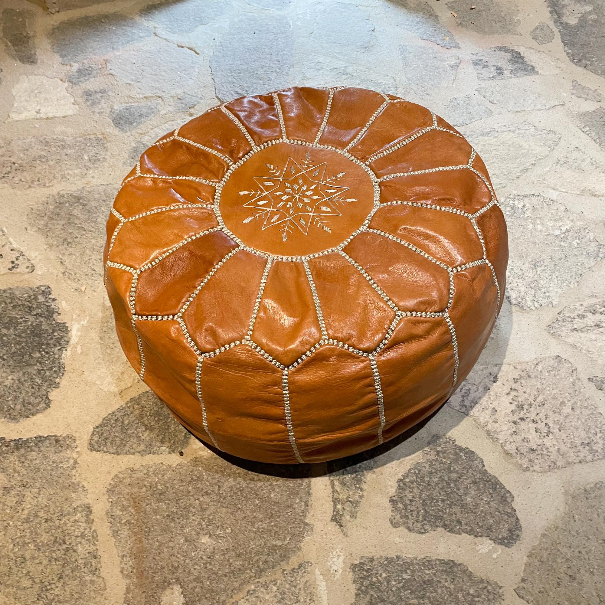 We presents: Radiant moroccan hand tooled saddle leather low stool round pouf ottoman with intricate stitch embroidery detail.
Features Zippered cover. Unmarked.
In the style of Berber Tribes of Morocco
Measures: 10 height x 21.5 inches