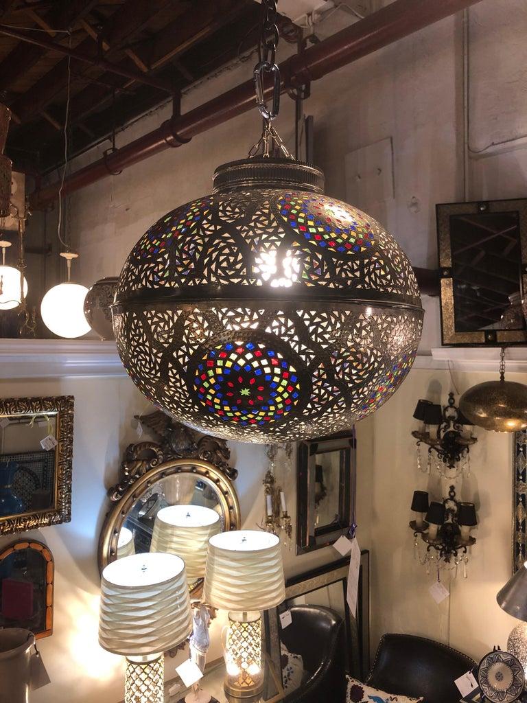 Moroccan round silver pendant or chandelier handmade with multi-color glass
An elegant and one of kind Moroccan silver metal handmade round shaped pendant or chandelier. The pendant features intricate and highly ornamental design as well as handcut