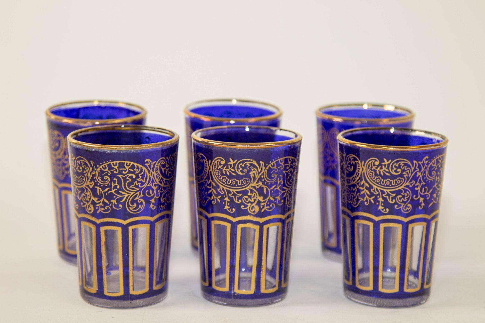 Moroccan Royal Blue Small Glasses with Gold Moorish Design.
Set of 6. Set of six royal cobalt blue shot drinking glasses barware with gold Moorish Arabesque design.
These beautiful Moroccan drinking glasses are decorated with a classical arabesque
