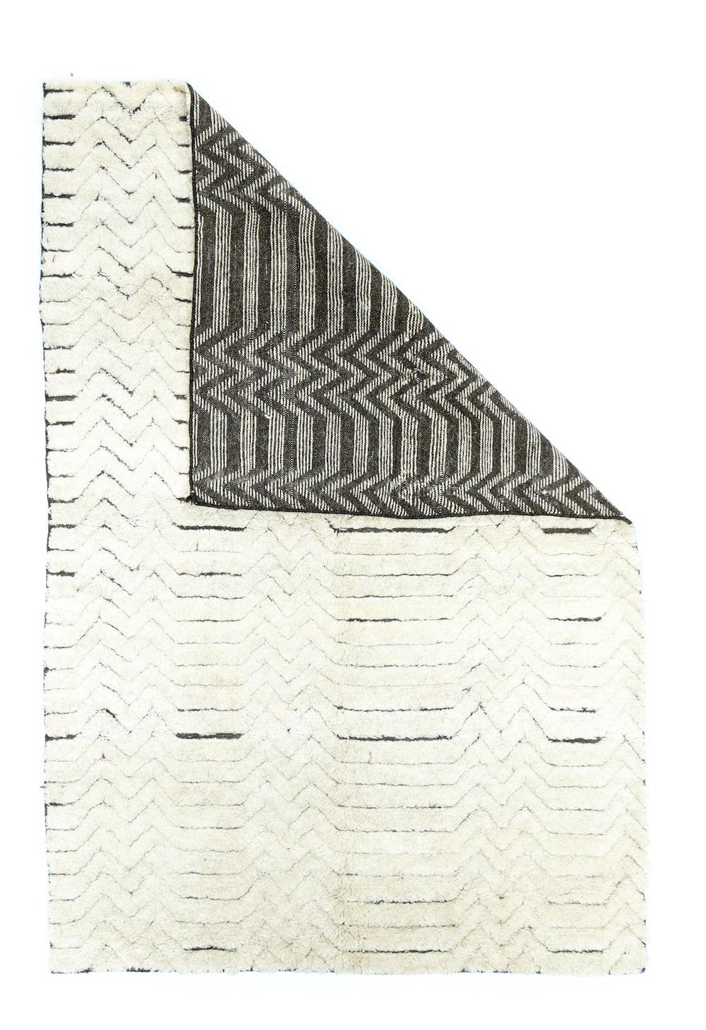 Moroccan Rug 5'0'' x 6'0''. The hopping dark horizontal lines vary in thickness and length. Chevrons at one edge, and horizontal parallels at the other. Bitonal in cream and charcoal. High pile, coarse weave. Recent.