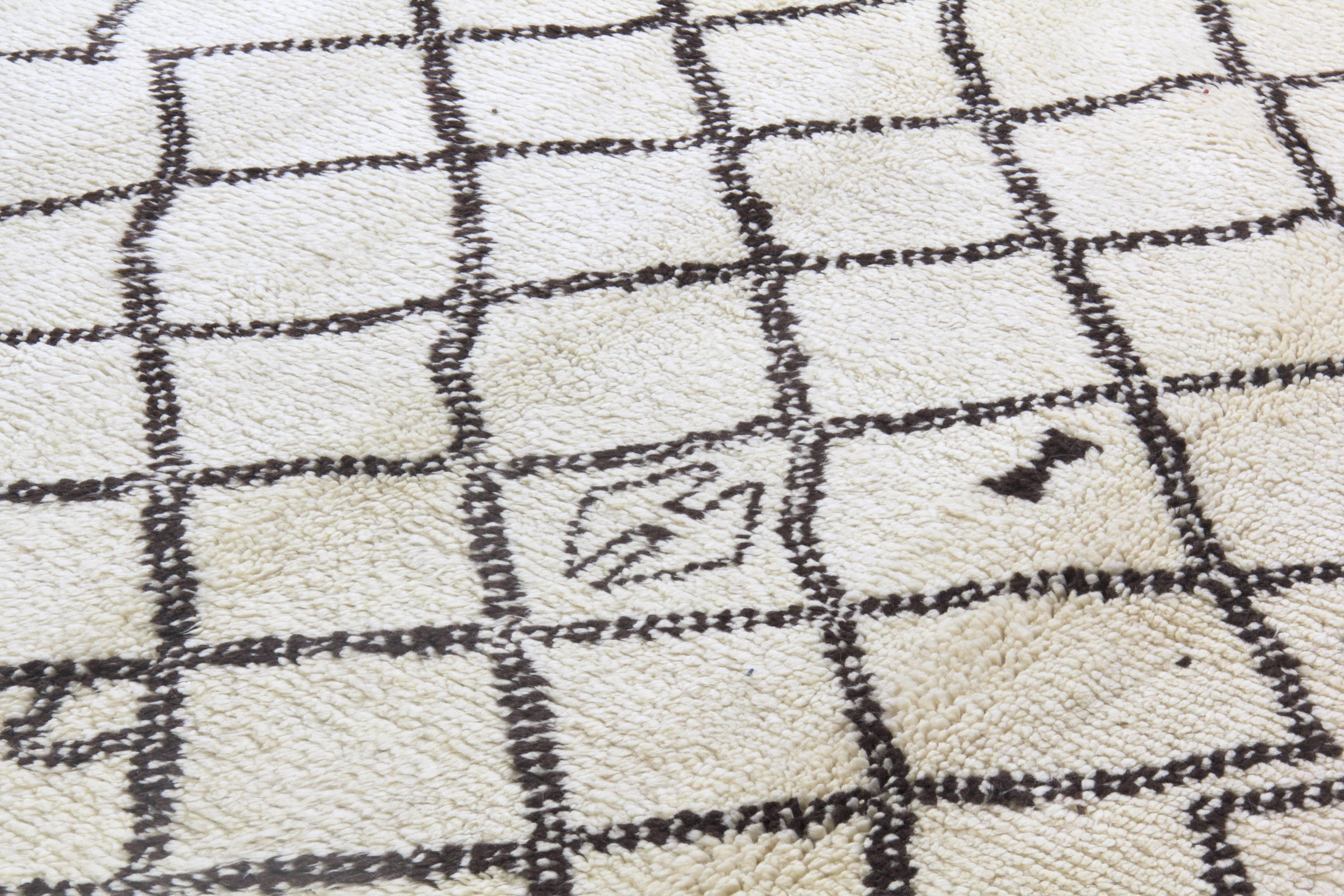 A new handmade rug made of natural un-dyed ivory / cream and dark brown sheep wool.
The design is inspired from vintage Moroccan rugs.
The rug is available as seen or if requested, it can be custom produced in a different size, color combination and