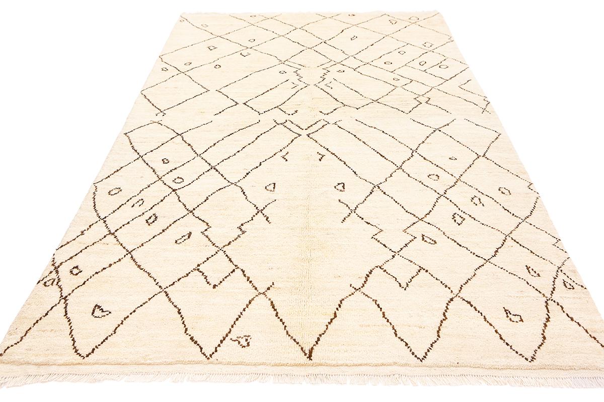This is an exceptional Moroccan Rug, specifically a Beni Ourain Berber rug, handwoven with all-wool. This remarkable piece embodies the rich cultural heritage of the Berber tribes of Morocco and stands out for its unique qualities and timeless