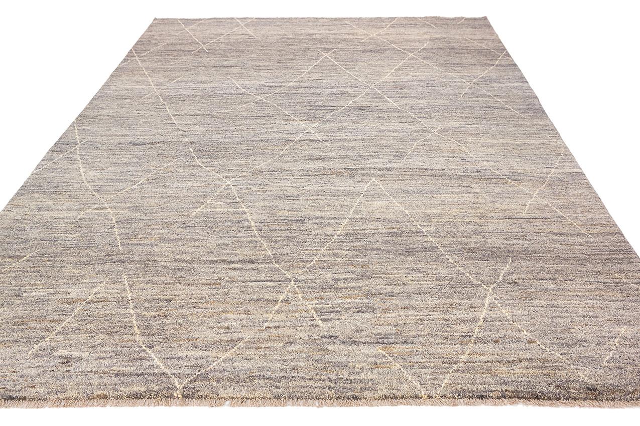 This is a Moroccan Rug, hand-knotted from genuine wool, featuring an elegant minimalist design that seamlessly blends tradition with modernity. This rug is a masterpiece that celebrates the beauty of simplicity and the enduring craftsmanship of
