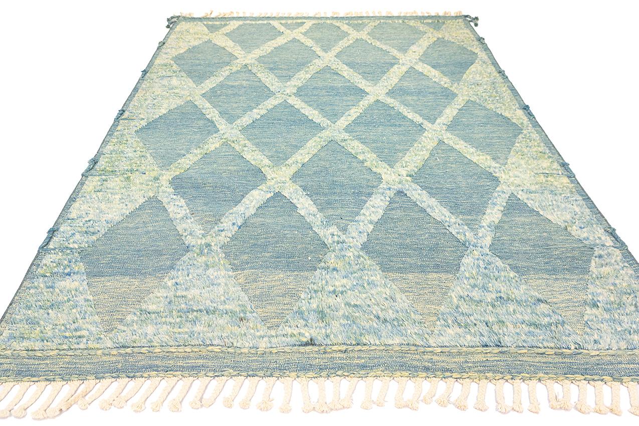 This is a Moroccan Rug, a labor of love handcrafted from genuine wool and adorned with a captivating color palette of blue and green. This rug is not merely a floor covering; it is a symphony of artistry and nature's beauty into your living space.