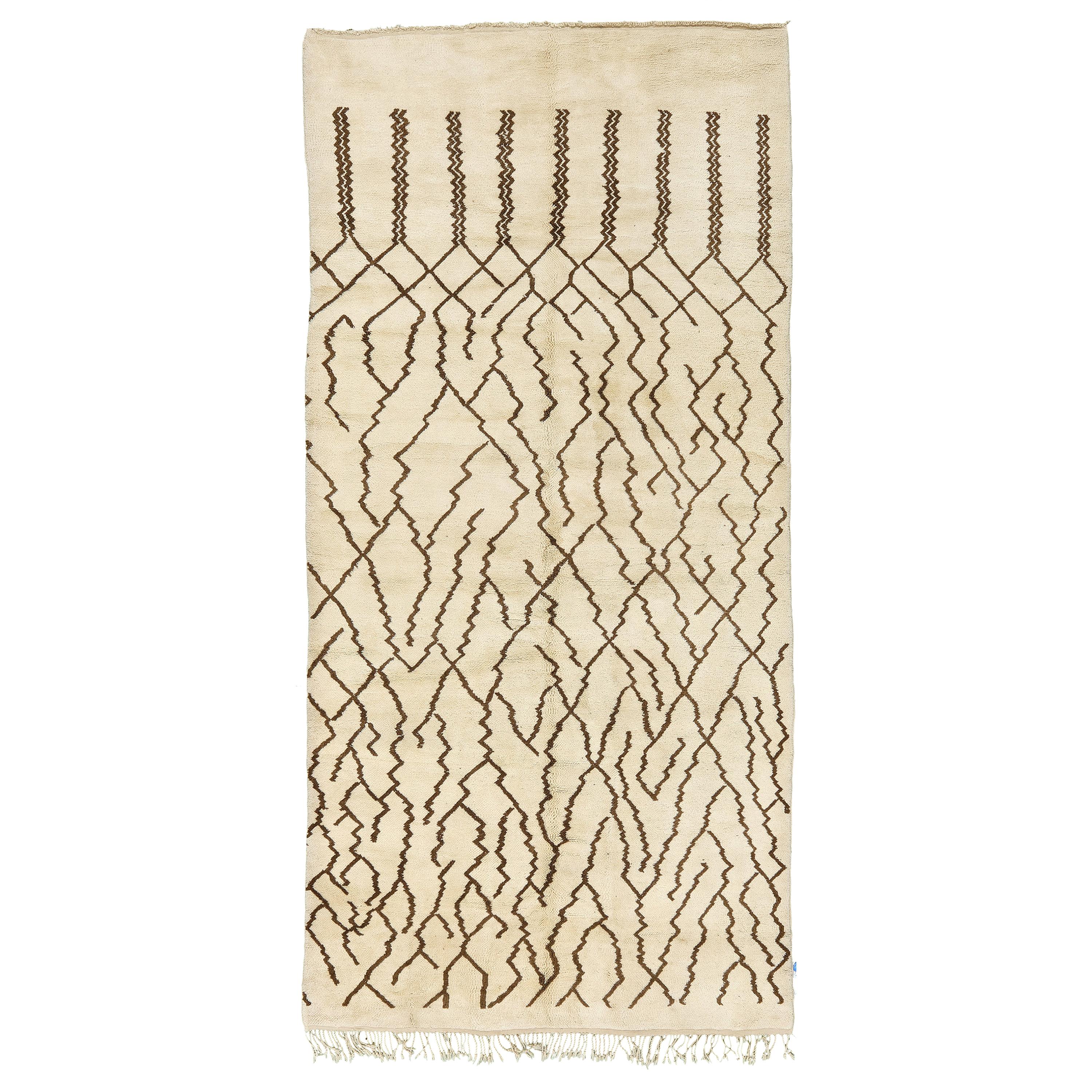 Style to impress with this geometrically abstract rug made from Morocco in Middle Atlas collection. A field of sand enhances the chocolate brown extended lozenges and zigzag patterns. The stunning beauty of impressive creation that will make your