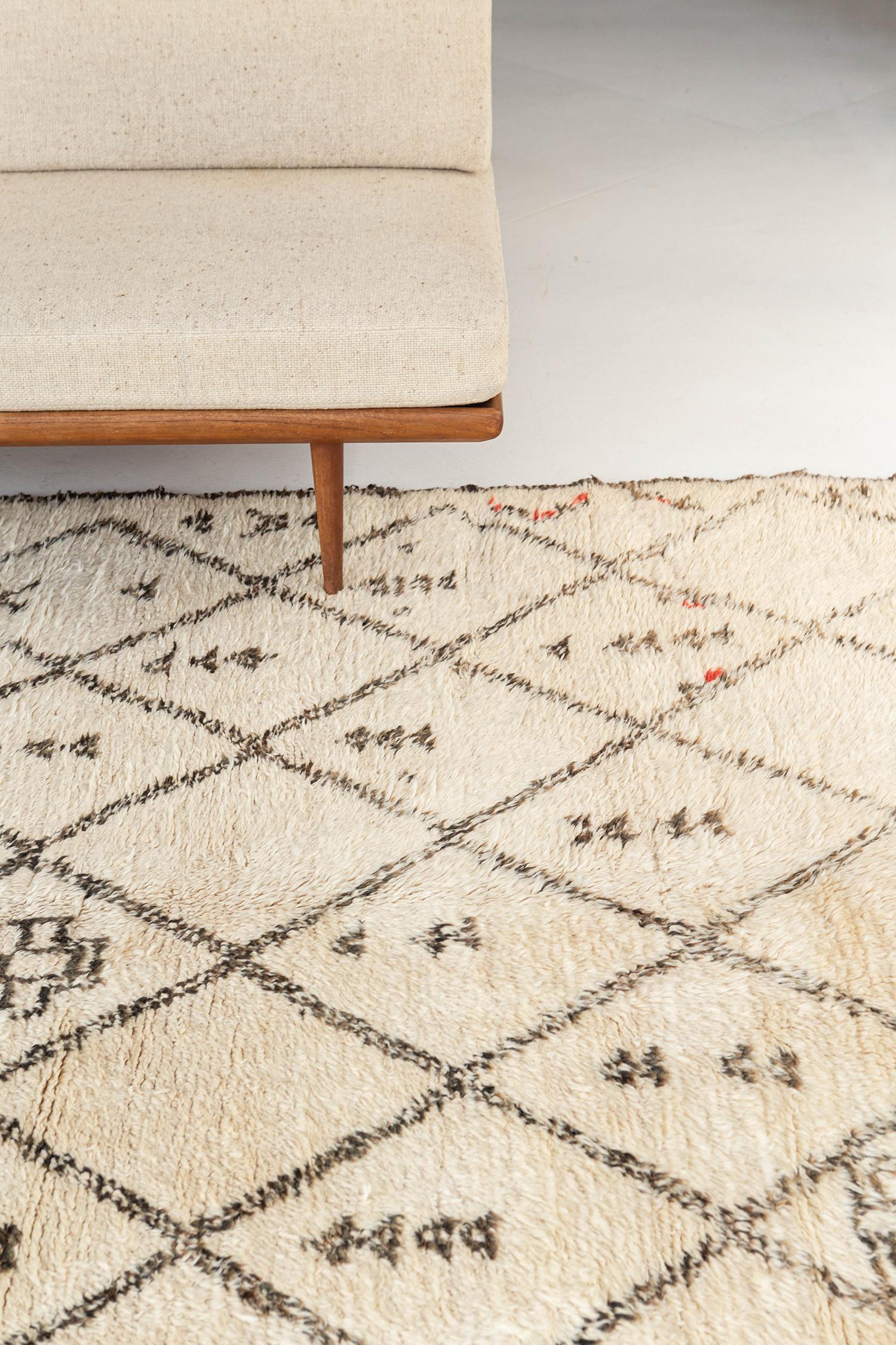 Be captivated by this luxurious Middle Atlas rug all the way from Morocco from our Atlas collection. It has a diamond pattern all the way through the natural ivory rug and showcases the different symbols which made it more unique. Sink your feet