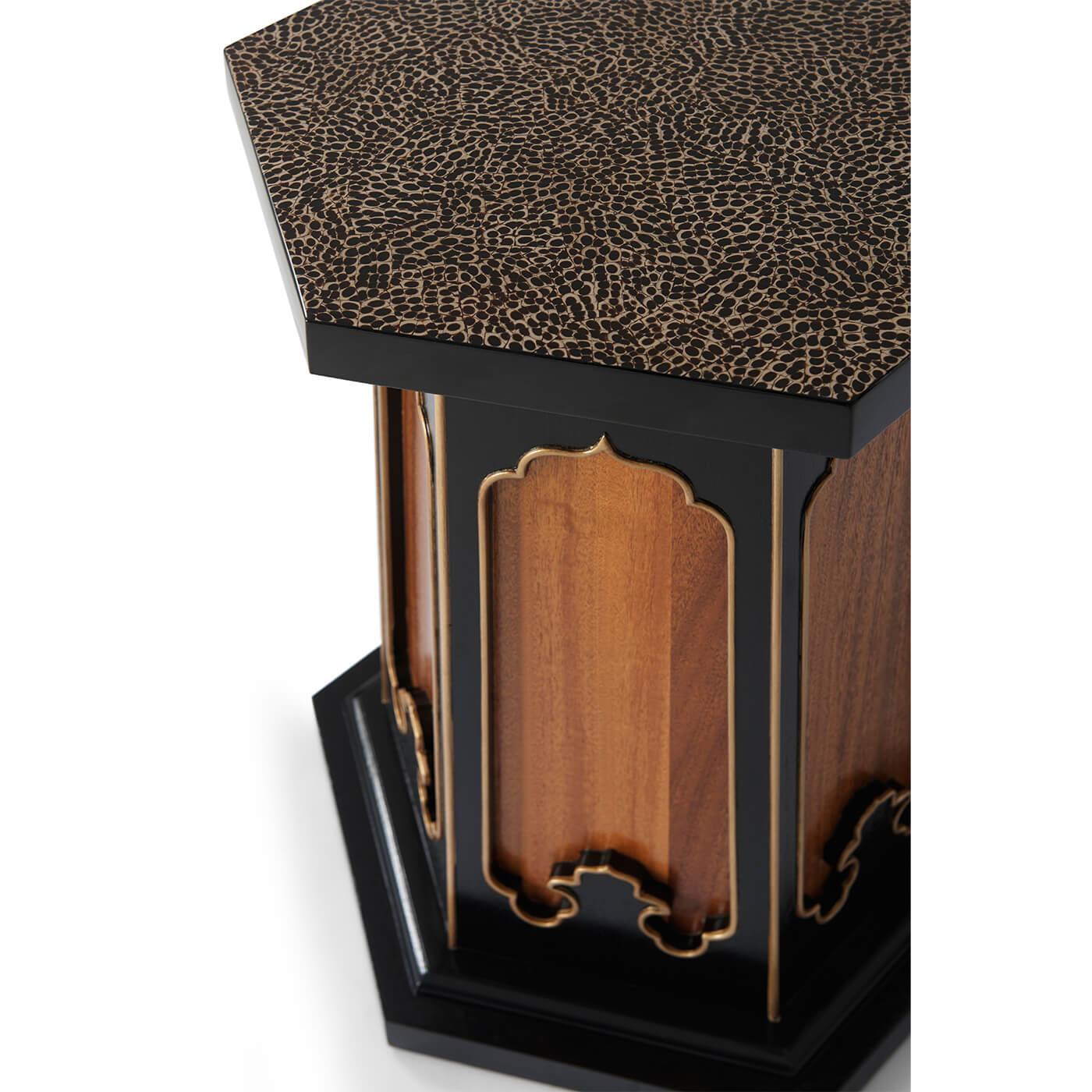 A Moorish style mid-century accent table. With Moorish recessed panels framed in ebony with gilt details repeat on the end table’s hexagon base. The eggshell inlaid tabletop is perfect for a cocktail – or two. Set on a plinth base.

Dimensions: