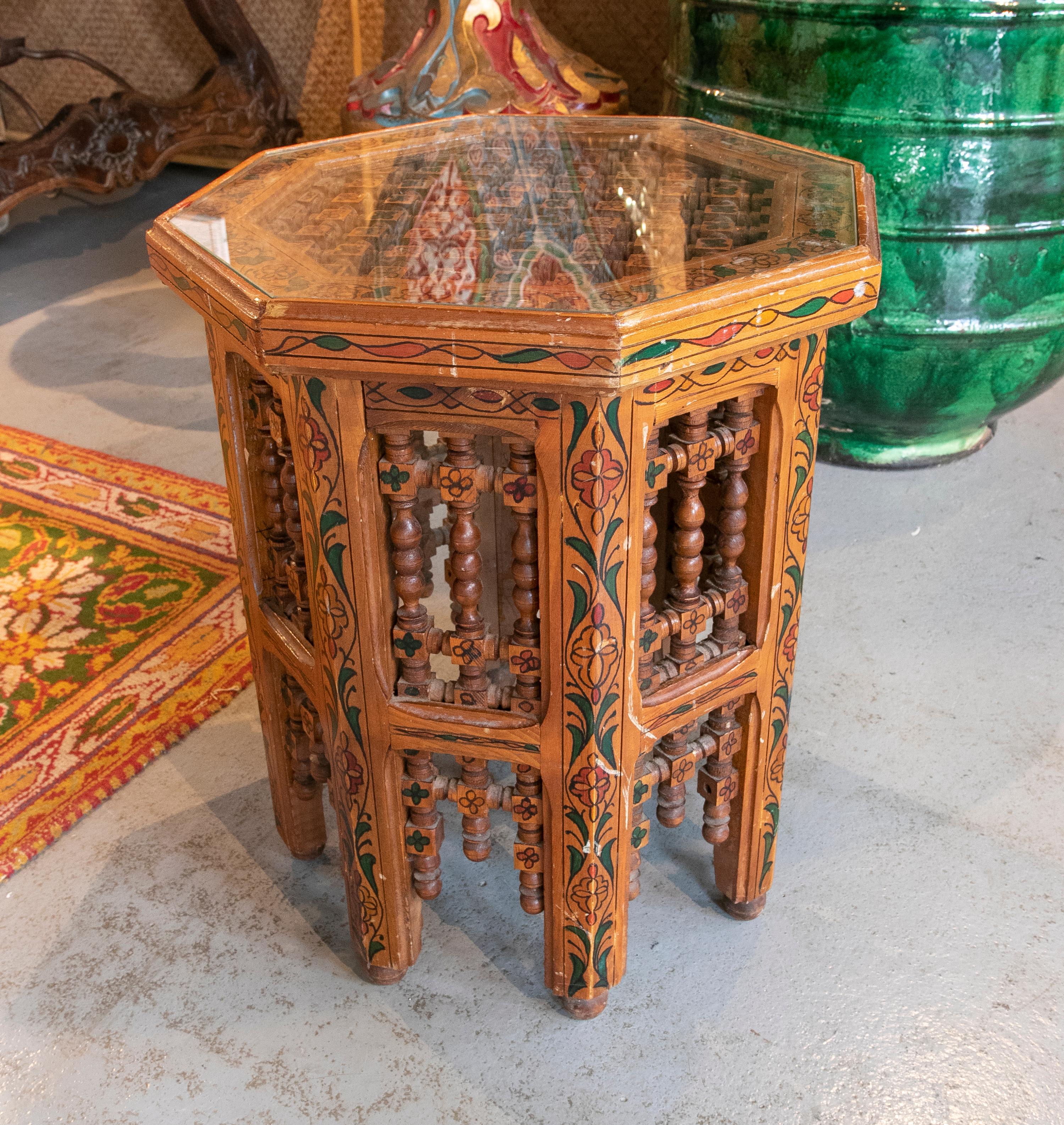 Moroccan side table in carved and hand painted wood.