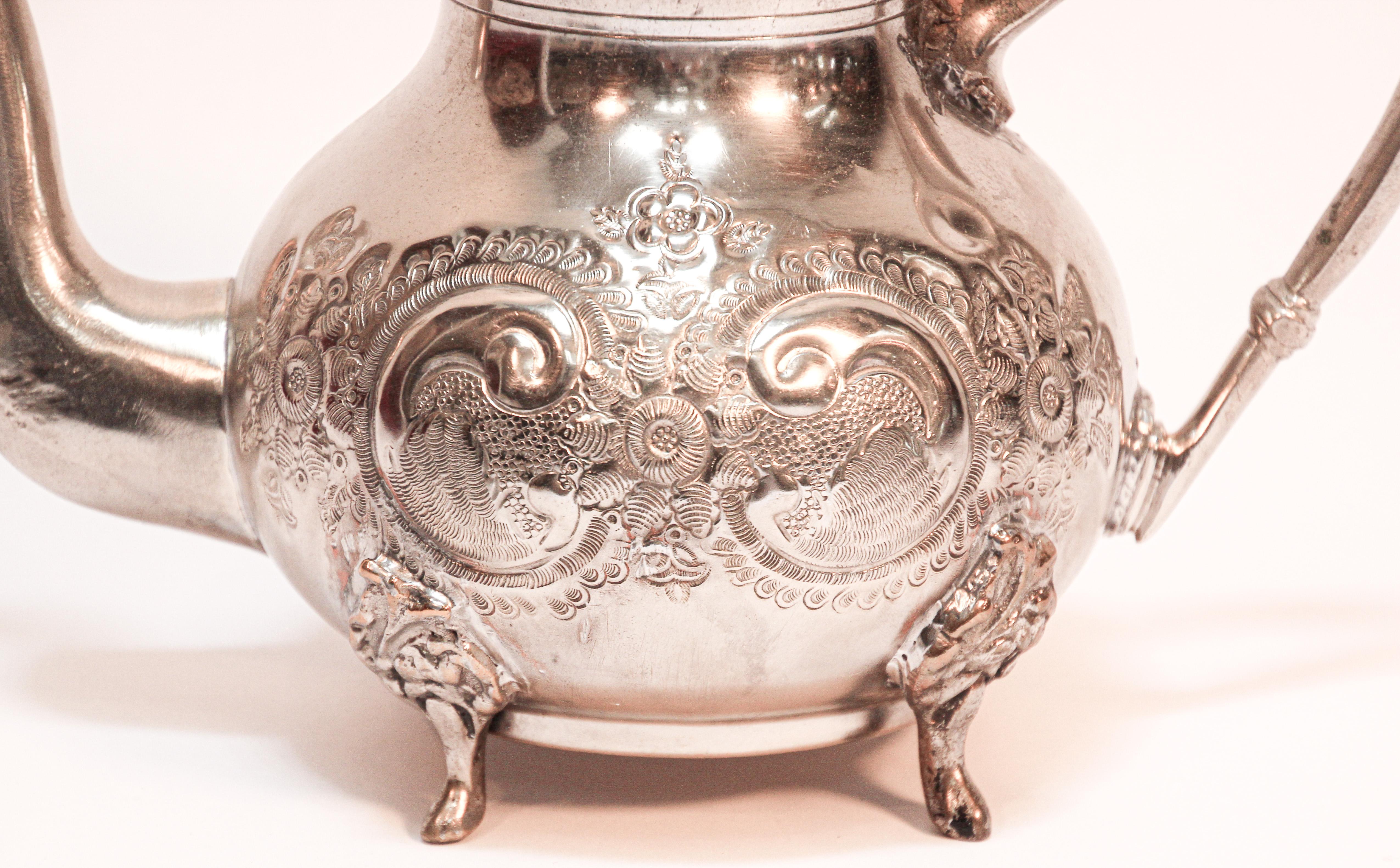 Traditional vintage silver plated and brass Moroccan tea pot, embossed with traditional repousse design, nicely aged, handcrafted in Fez, stamped in bottom.
Great silver plated and brass decorative Islamic art object.
Will make a great gift.